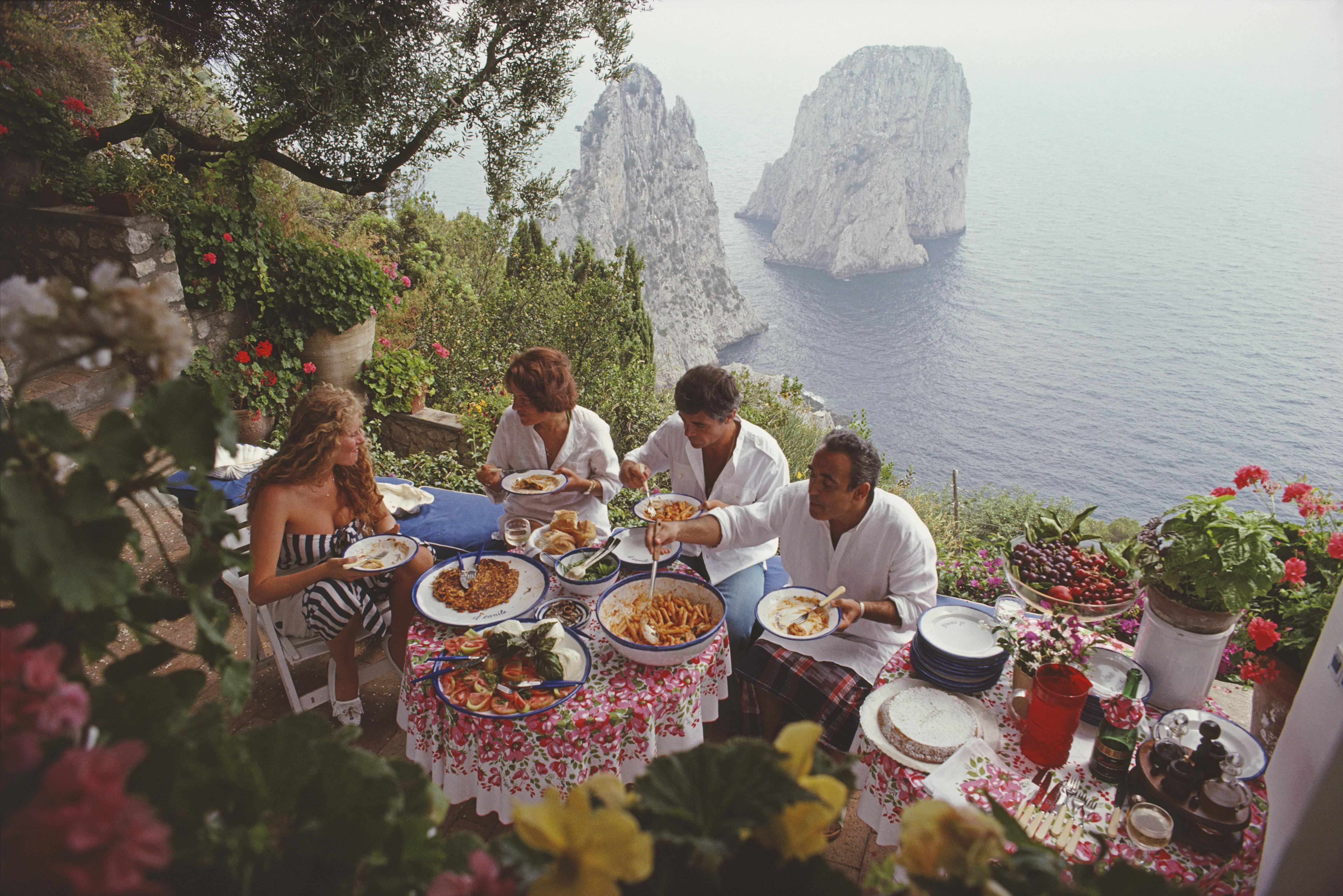 Slim Aarons
Dining Al Fresco On Capri 
1980 (printed later)
C print 
Estate stamped and numbered edition of 150 
with Certificate of authenticity

Italian artist and actress Domiziana Giordano, Italian author Francesca Sanvitale (1928 - 2011), Dino