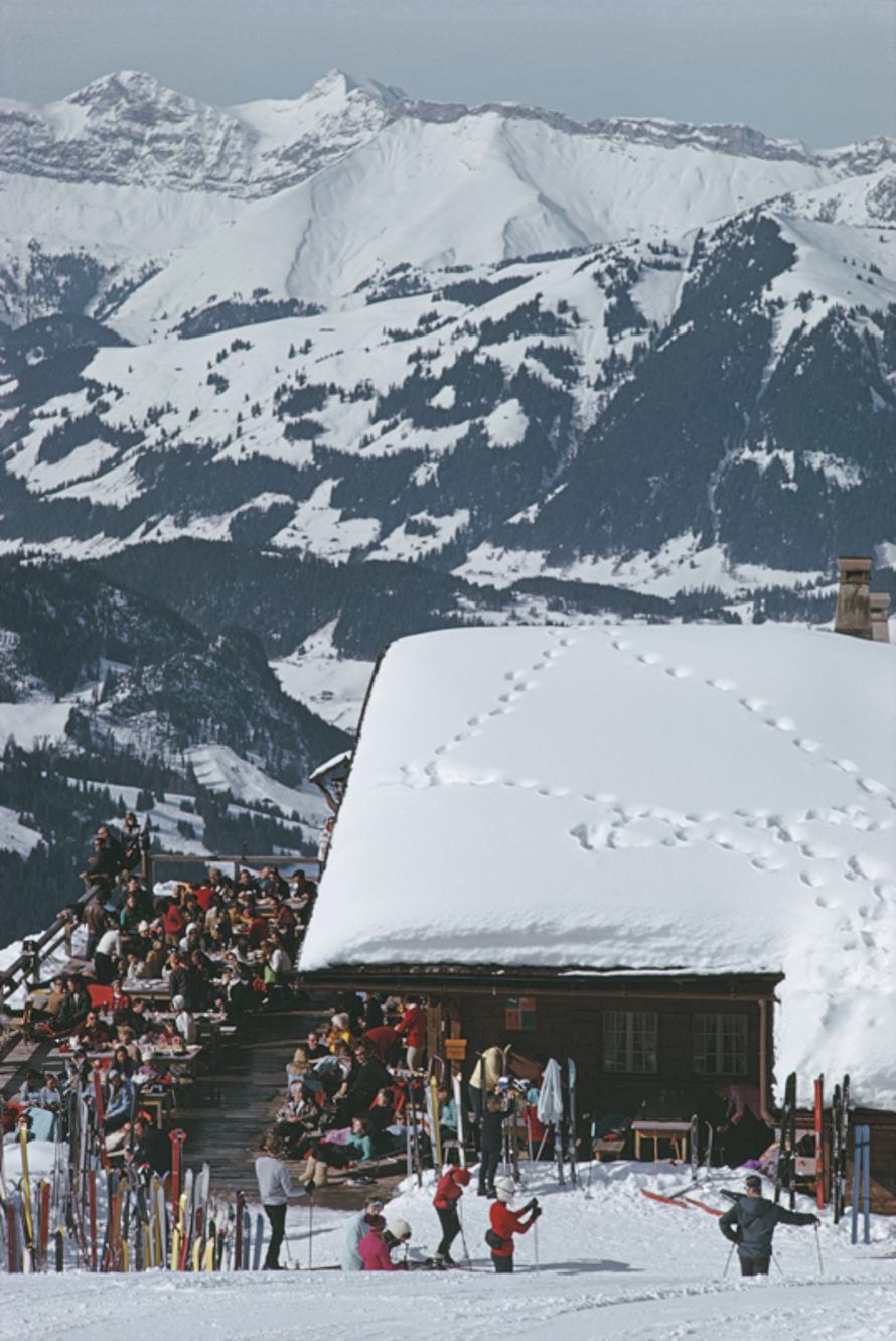 Dining At The Eagle Club 
1969
by Slim Aarons

Slim Aarons Limited Estate Edition

Holidaymakers dining at the Eagle Club in the ski resort of Gstaad, Switzerland, 1969

unframed
c type print
printed 2023
24 x 20"  - paper size

Limited to 150
