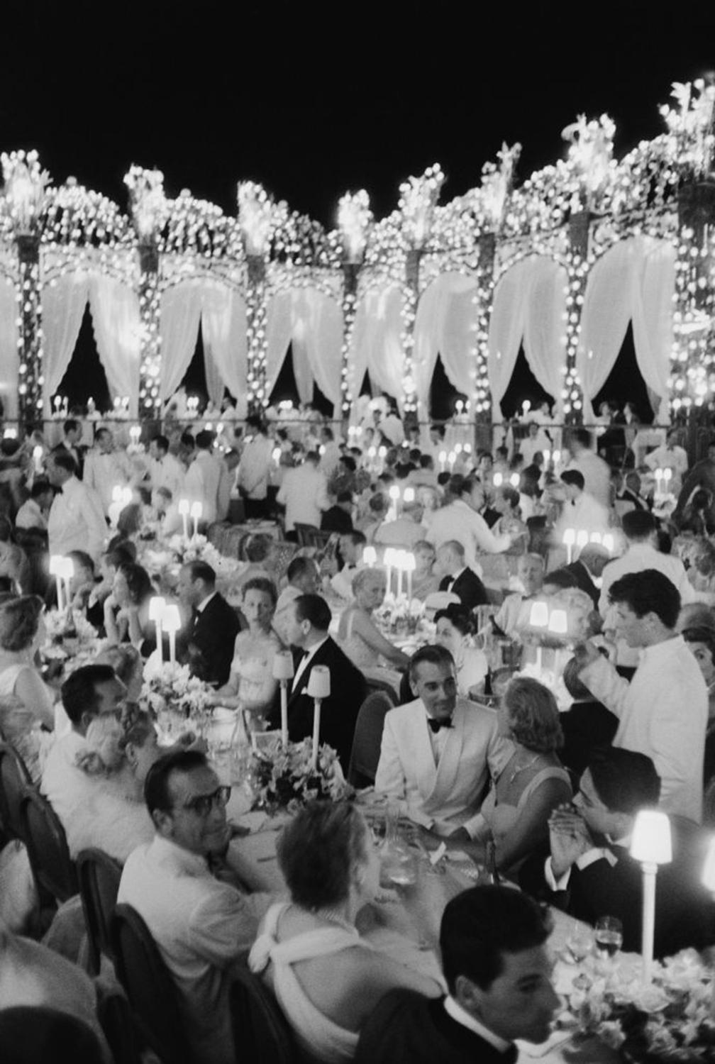 This early 1950s portrait photograph, captured by society photographer Slim Aarons, features a formal dinner organised by Dubonnet on the French Riviera.

This is an estate stamped and hand numbered edition of 150 with certificate of authenticity