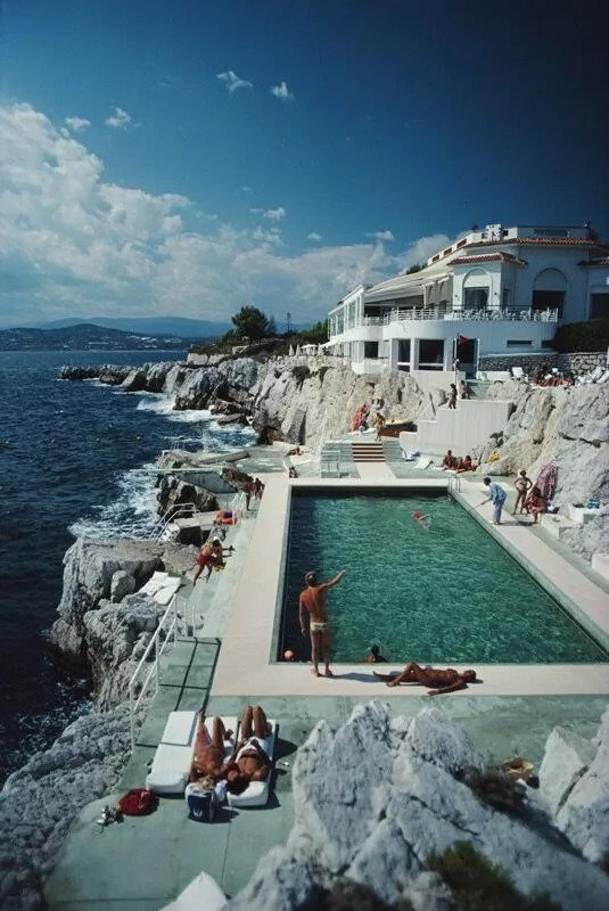 Eden-Roc Pool 
1976
by Slim Aarons

printed 2024
Slim Aarons Limited Estate Edition

Guests round the swimming pool at the Hotel du Cap Eden-Roc, Antibes, France, August 1976.
 
unframed
c type print
Very large 72 × 48″ inches / 183 x 122 cm paper