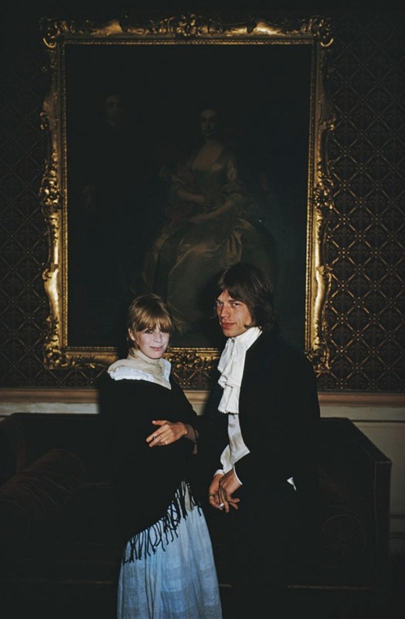Faithful Couple 
1968
by Slim Aarons

Slim Aarons Limited Estate Edition

Singer Marianne Faithfull and Mick Jagger of the Rolling Stones stand in front of a gilt framed portrait in Castletown Mansion, Eire, August 1968

unframed
c type