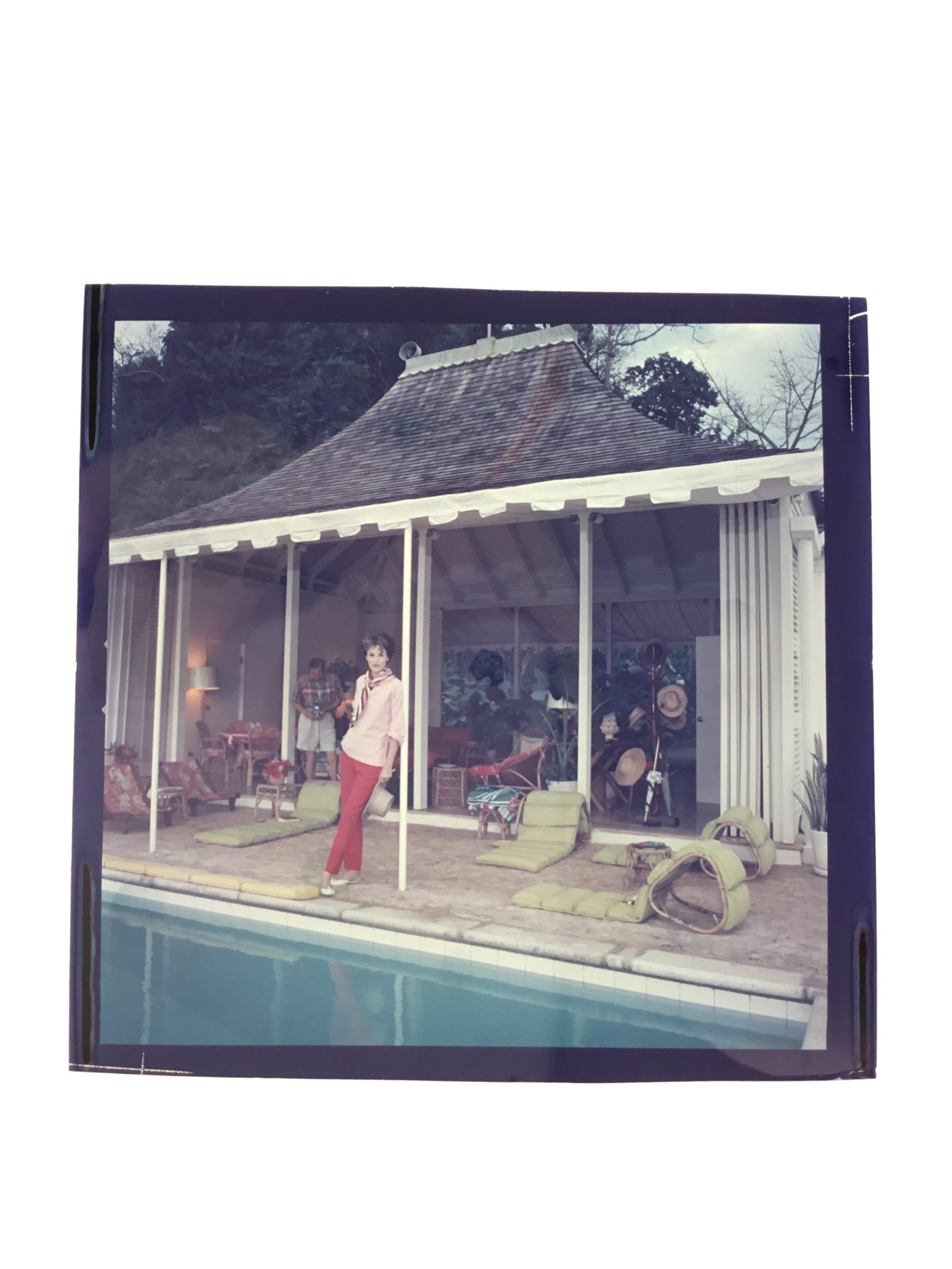 1959: Babe Paley (Mrs William Paley) by the pool. Her husband, William Paley is snapping the photographer at their cottage, Round Hill, Jamaica. A Wonderful Time - Slim Aarons (Photo by Slim Aarons/Getty Images)

C-type print from the original