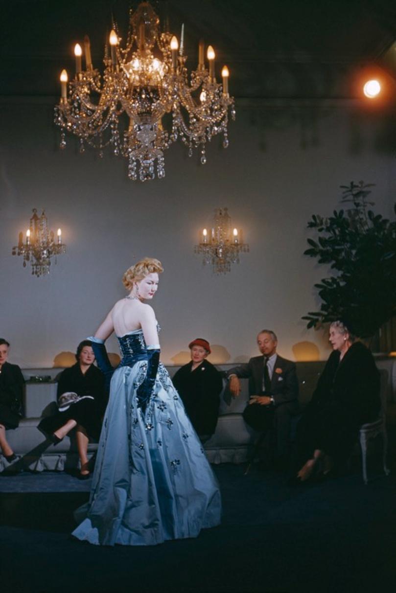 Fashion At Hartnell’s 
1955
by Slim Aarons

Slim Aarons Limited Estate Edition

A fashion show at the Burton Street salon of British couturier and court dressmaker Norman Hartnell, London, 1955. 

unframed
c type print
printed 2023
24 x 20"  - paper