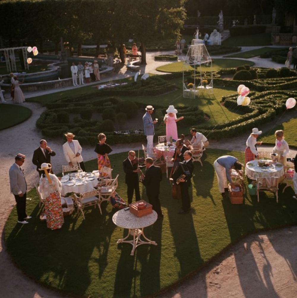Garden Party 
1970
by Slim Aarons

Slim Aarons Limited Estate Edition

1970: An elegant garden party in Miami, Florida. 

unframed
c type print

numbered in ink on the front

Limited to 150 prints only – regardless of paper size

blind embossed Slim