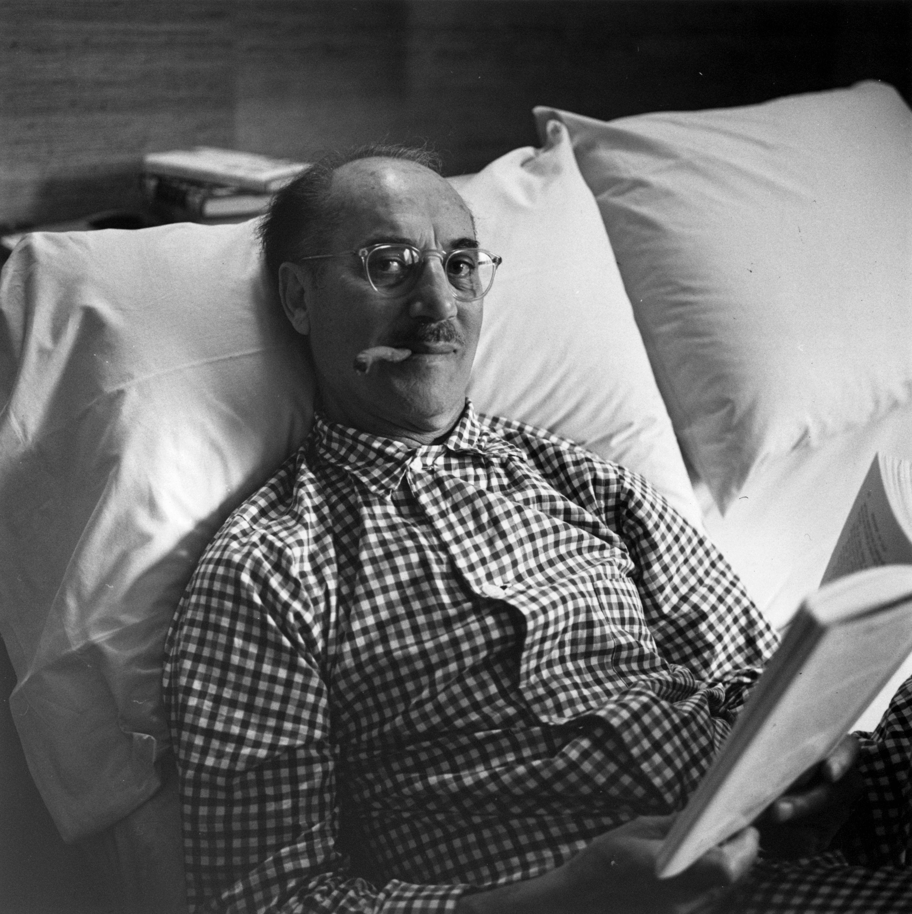 American comic Julius 'Groucho' Marx (1895 - 1977), member of the Marx brothers, in bed with a joke cigar in Beverly Hills, California.

Signed in black archival ink on recto, bottom right. Numbered in black archival ink on recto, bottom left.