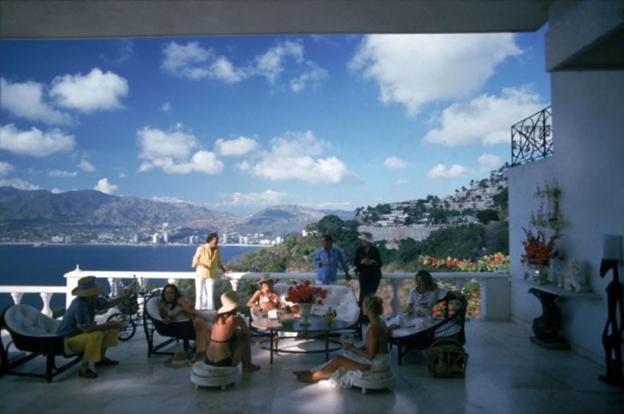 Guests At Villa Nirvana 
1978
by Slim Aarons

Slim Aarons Limited Estate Edition

Guests at the Villa Nirvana, owned by Oscar Obregon, in Las Brisas, Acapulco, Mexico, 1978

unframed
c type print
printed 2023
16 x 20" - paper size

Limited to 150