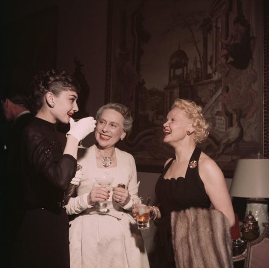 Hepburn And Friends
1953
by Slim Aarons

Slim Aarons Limited Estate Edition

1953 On the left film star Audrey Hepburn (1929 – 1993) talks with Mrs Grover Magnin (centre) and another guest at a party in San Francisco.

unframed
c type print
printed