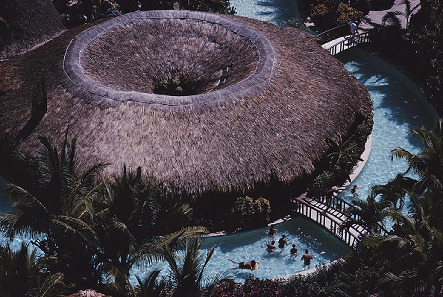 Slim Aarons Portrait Photograph - Hilton Hotel Pool Bar - View of Swimming Pool and Palm Trees in Acapulco Mexico