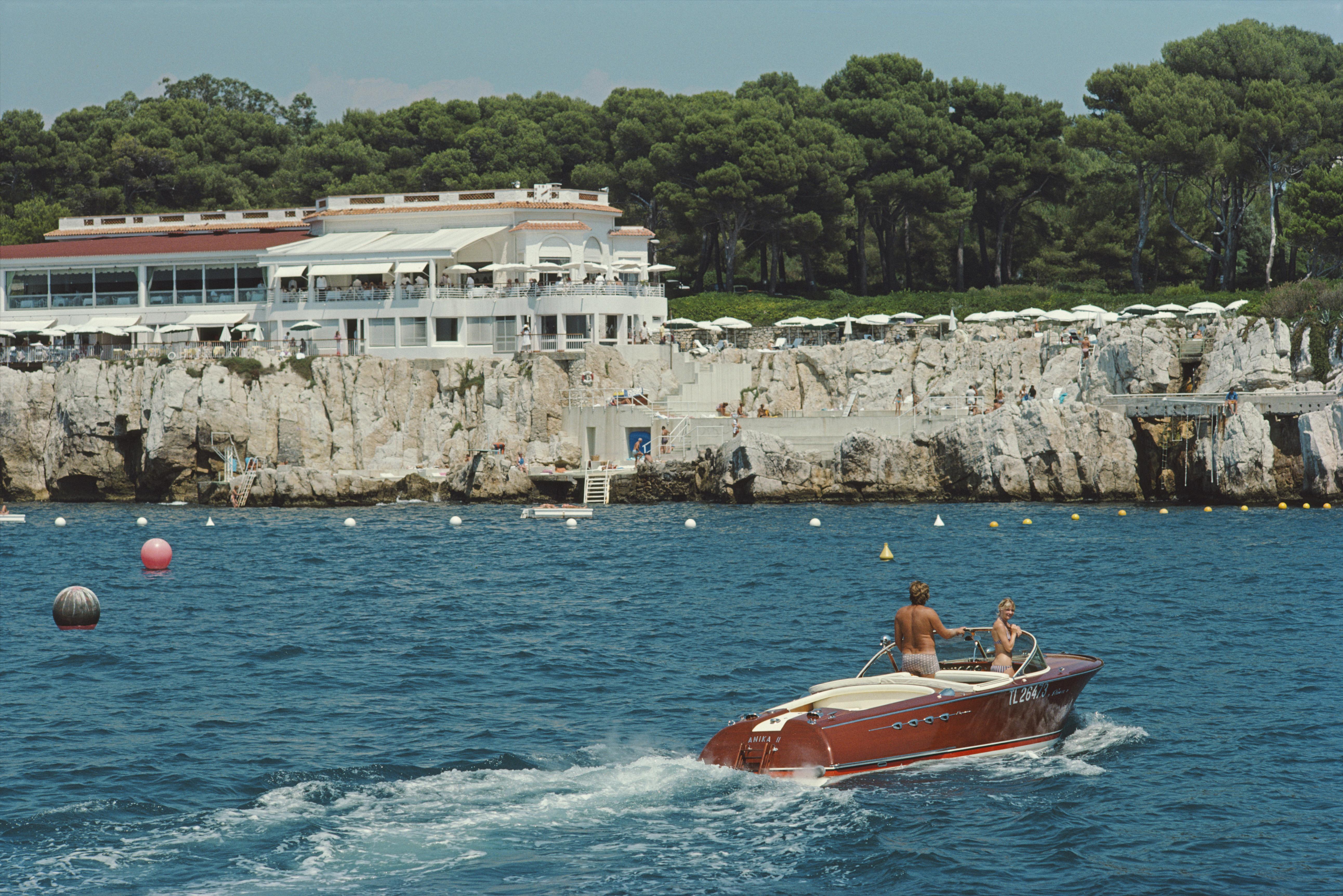 'Hotel Du Cap-Eden-Roc' 1969 Slim Aarons Limited Estate Edition Print 

Holidaymakers in a motorboat off the Hotel du Cap-Eden-Roc in Antibes on the French Riviera, 1969. 

Produced from the original transparency
Certificate of authenticity supplied