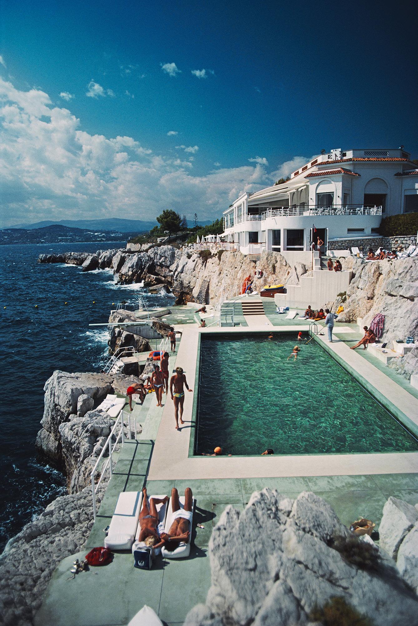 'Hotel du Cap Eden-Roc' 1976 Slim Aarons Limited Estate Edition

Guests by the pool at the Hotel du Cap Eden-Roc, Antibes, France, August 1976. 

Produced from the original transparency
Certificate of authenticity supplied 
30x40 inches / 76 x 102