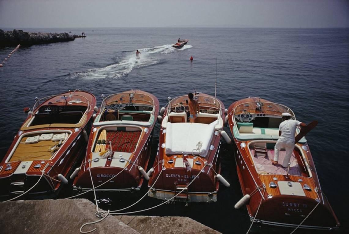 'Hotel Du Cap-Eden-Roc' by Slim Aarons

ESTATE EDITION -

numbered and emboss stamped on front. (edition size 150 only)

Waterskiing from the Hotel Du Cap-Eden-Roc in Cap d'Antibes, France, 1969.

Four stylish and iconic wooden Riva motorboats are