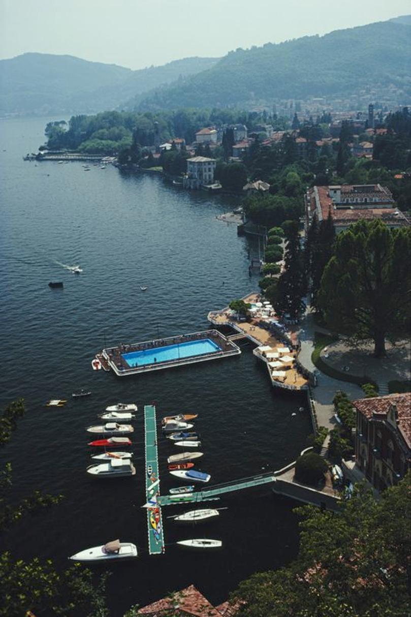 Hotel En El Lago Como 
1983
por Slim Aarons

Slim Aarons Edición Limitada Estate

 La piscina y el embarcadero del Hotel Villa d'Este, Lago Como, Italia, junio de 1983.

sin enmarcar
c escribir imprimir
impreso 2023
20 × 16 pulgadas - tamaño del