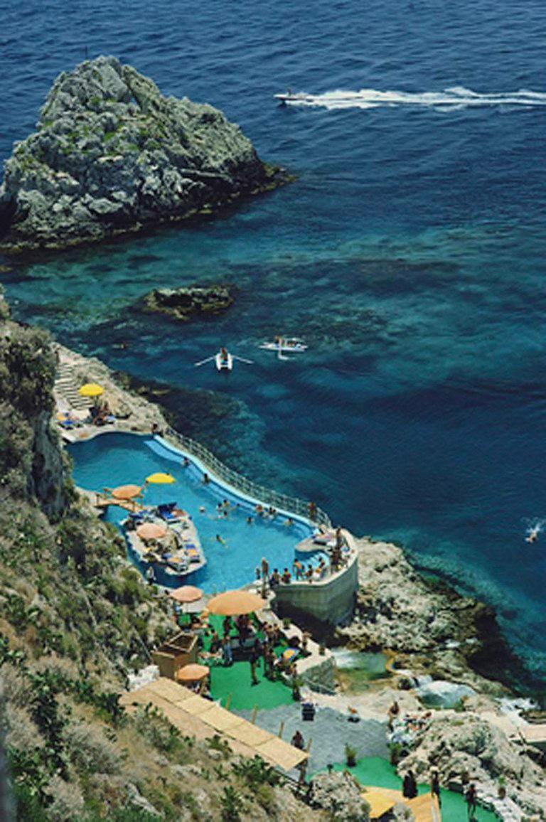 Slim Aarons Figurative Photograph - Hotel Taormina Pool Sicily, Estate Edition, Landscape Photograph Sea Rocky Shore