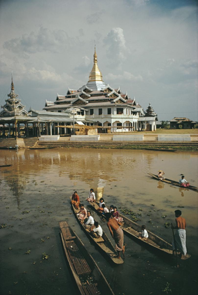 Hpaung Daw U Pagoda 
1971
by Slim Aarons

Slim Aarons Limited Estate Edition

Boatmen, using the local leg rowing technique, approaching the Hpaung Daw U Pagoda on Inle Lake in the Taunggyi District of Shan State, Myanmar (Burma), May 1971. The
