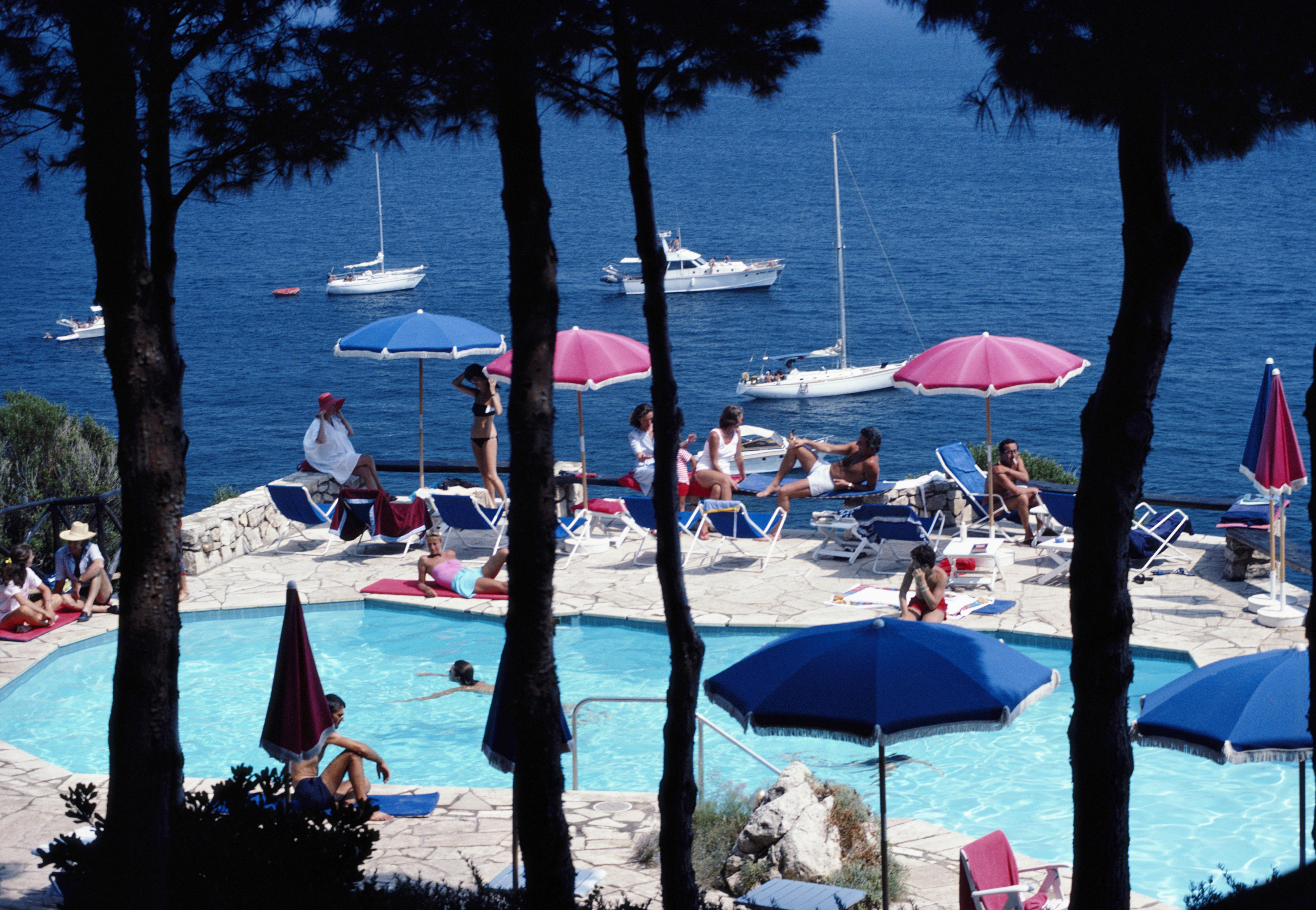 'Il Pellicano Hotel' 1980 Slim Aarons Limited Estate Edition Print 

Holidaymakers relax beside the swimming pool of Il Pellicano Hotel in Porto Ercole, Tuscany, August 1980. 

Produced from the original transparency
Certificate of authenticity