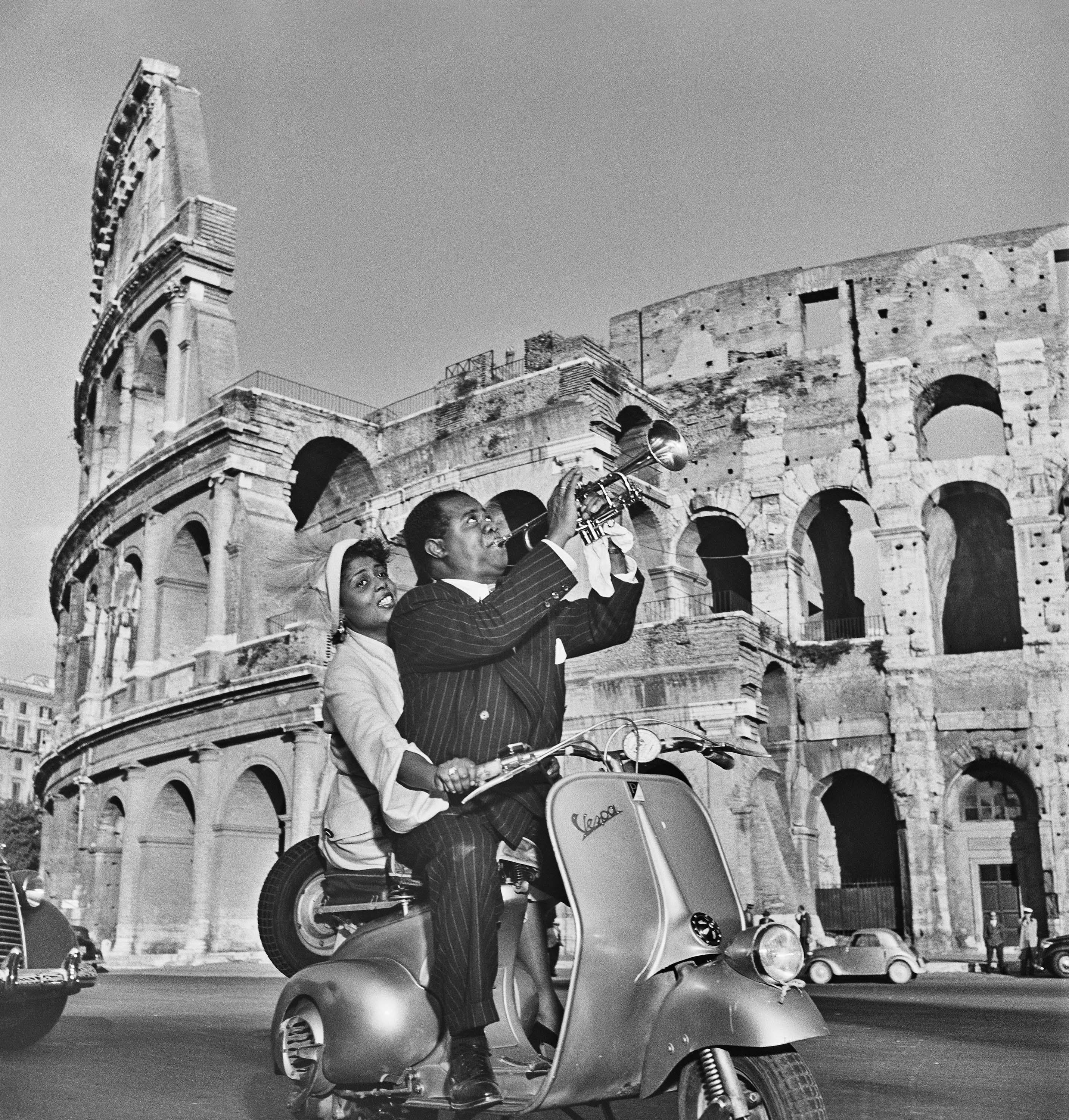 Slim Aarons Black and White Photograph - Jazz Scooter: Louis Armstrong and Lucille Brown in 1940s Rome, Estate Edition
