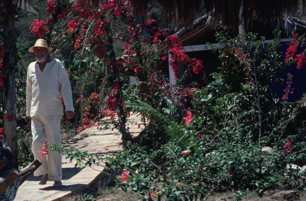 John Huston 
1979
by Slim Aarons

Slim Aarons Limited Estate Edition

April 1979: American film director John Huston walking barefoot through a garden at Puerto Vallarta in Mexico

unframed
c type print
printed 2023
20 x 24"  - paper size

Limited