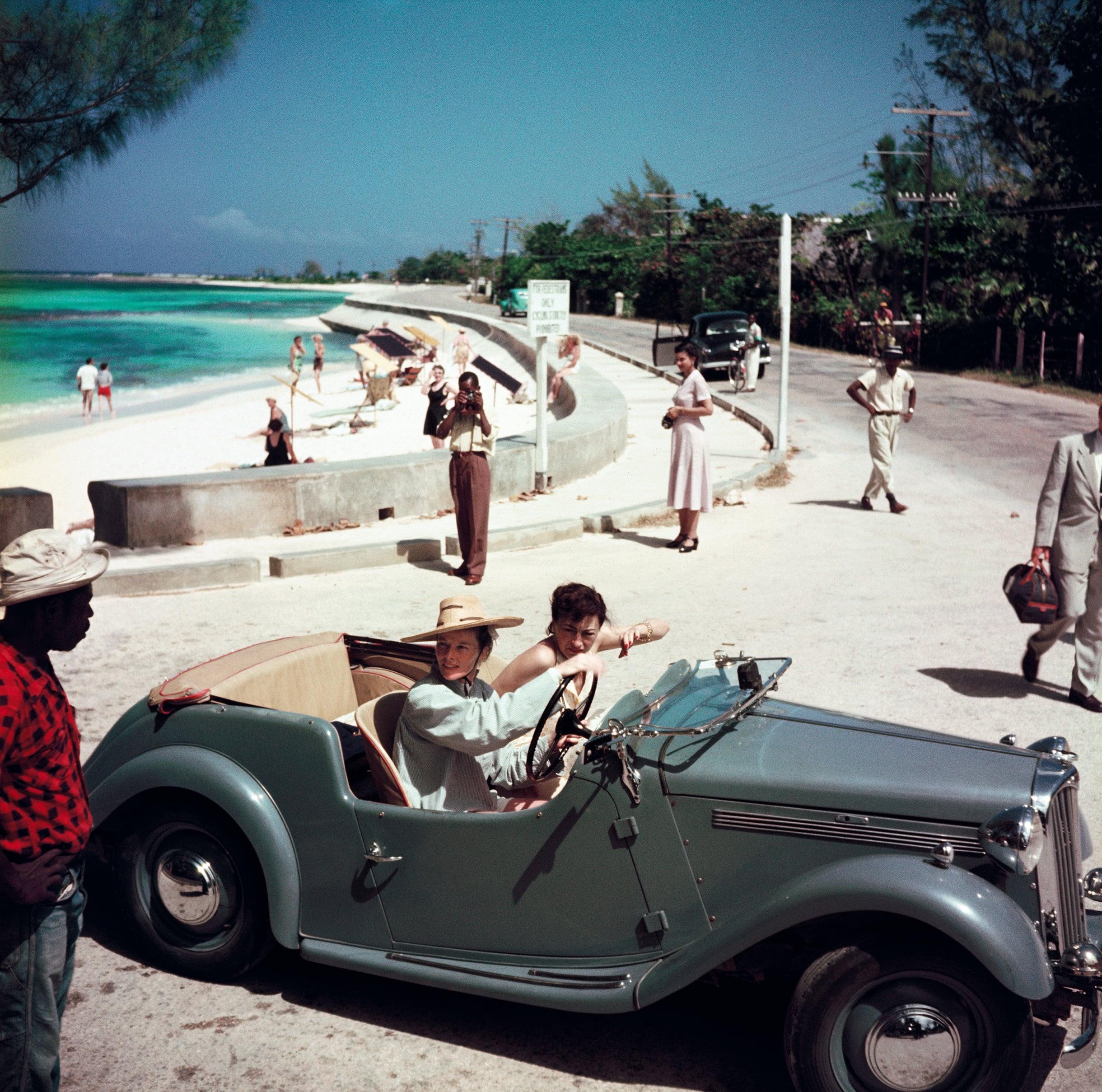 Katharine Hepburn 

1953 

1953: American film star Katharine Hepburn (1907 – 2003) driving along the waterfront with Irene Mayer Selznick at Montego Bay, Jamaica. 

(Photo by Slim Aarons)

60x60” / 152 x 152 cm - paper size 
Archival pigment