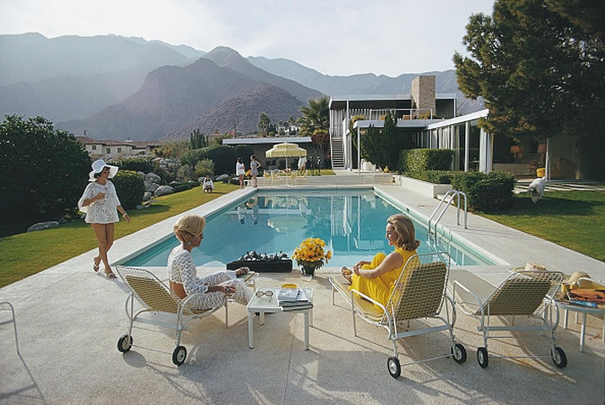 Catch Up by the Pool by Slim Aarons