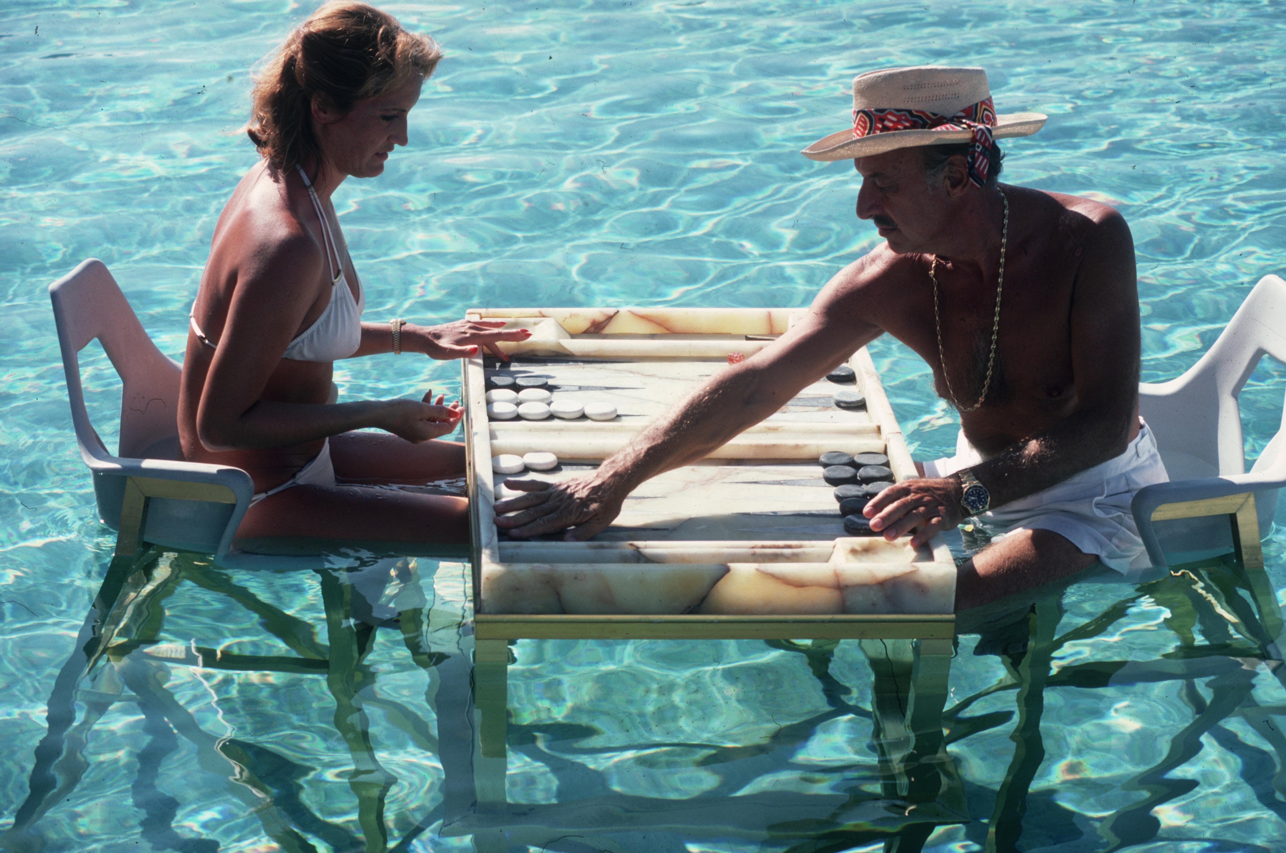 'Keep Your Cool' 1977 Slim Aarons Limited Estate Edition Print 

Carmen Alvarez enjoying a game of backgammon with Frank 'Brandy' Brandstetter in a swimming pool at Acapulco. 
(Photo by Slim Aarons/Getty Images)

Produced from the original