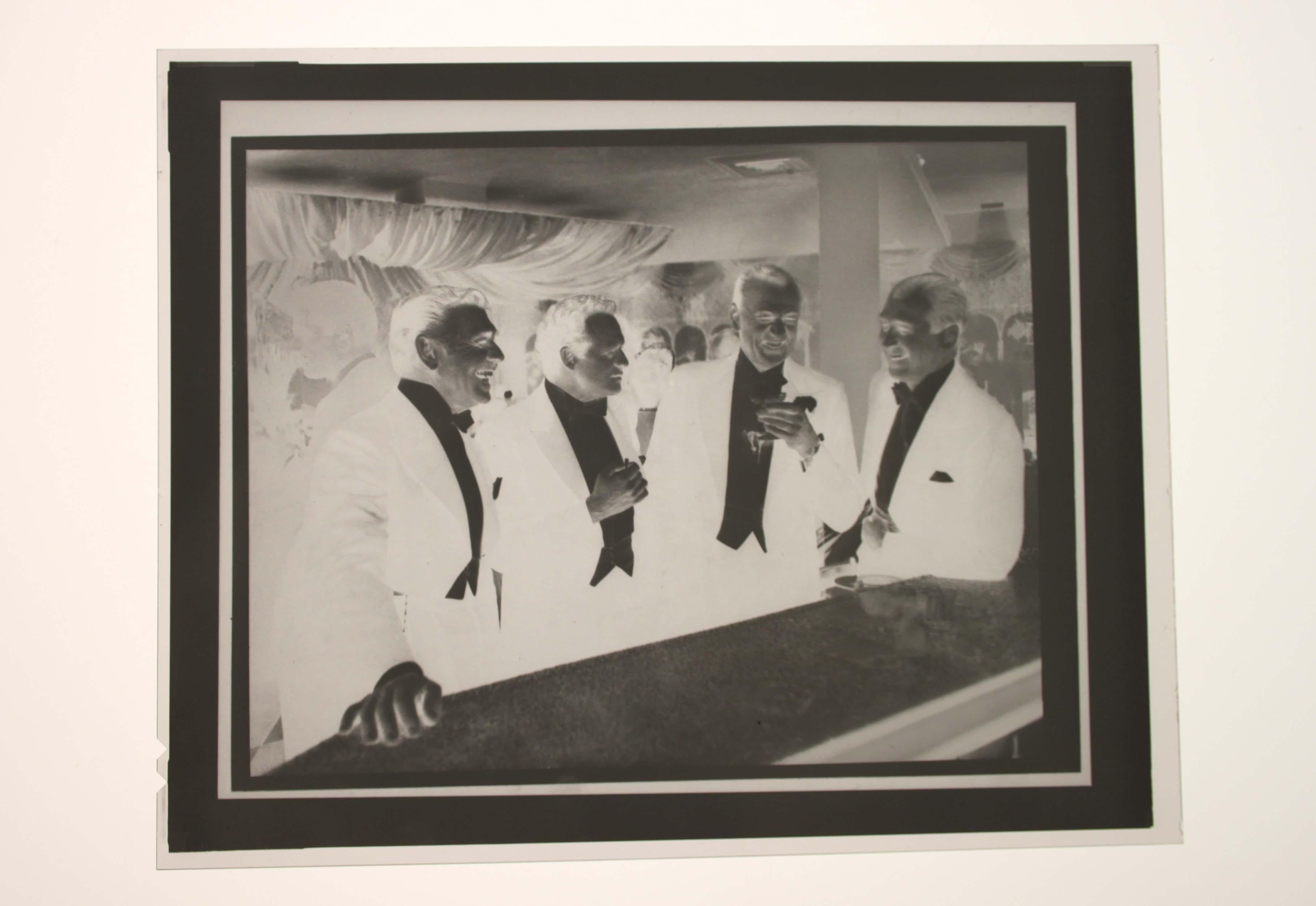 ‘Kings of Hollywood’ from 1957, is a signature post-war era photograph by American photographer Slim Aarons (1916-2006) capturing Classic Hollywood stars of the golden age.

Here Clark Gable, Van Heflin, Gary Cooper, and James Stewart enjoy a joke