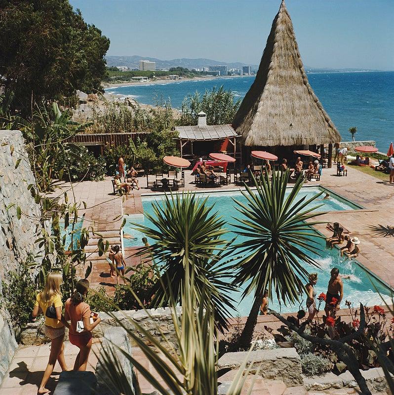 The swimming pool of the Marbella Club in Andalucia looks out over the sea, 1976.

This photograph is from the Estate Limited Edition of 150
30x30”
C-print, from the original transparency
Printed later
With artist embossed signature and handwritten