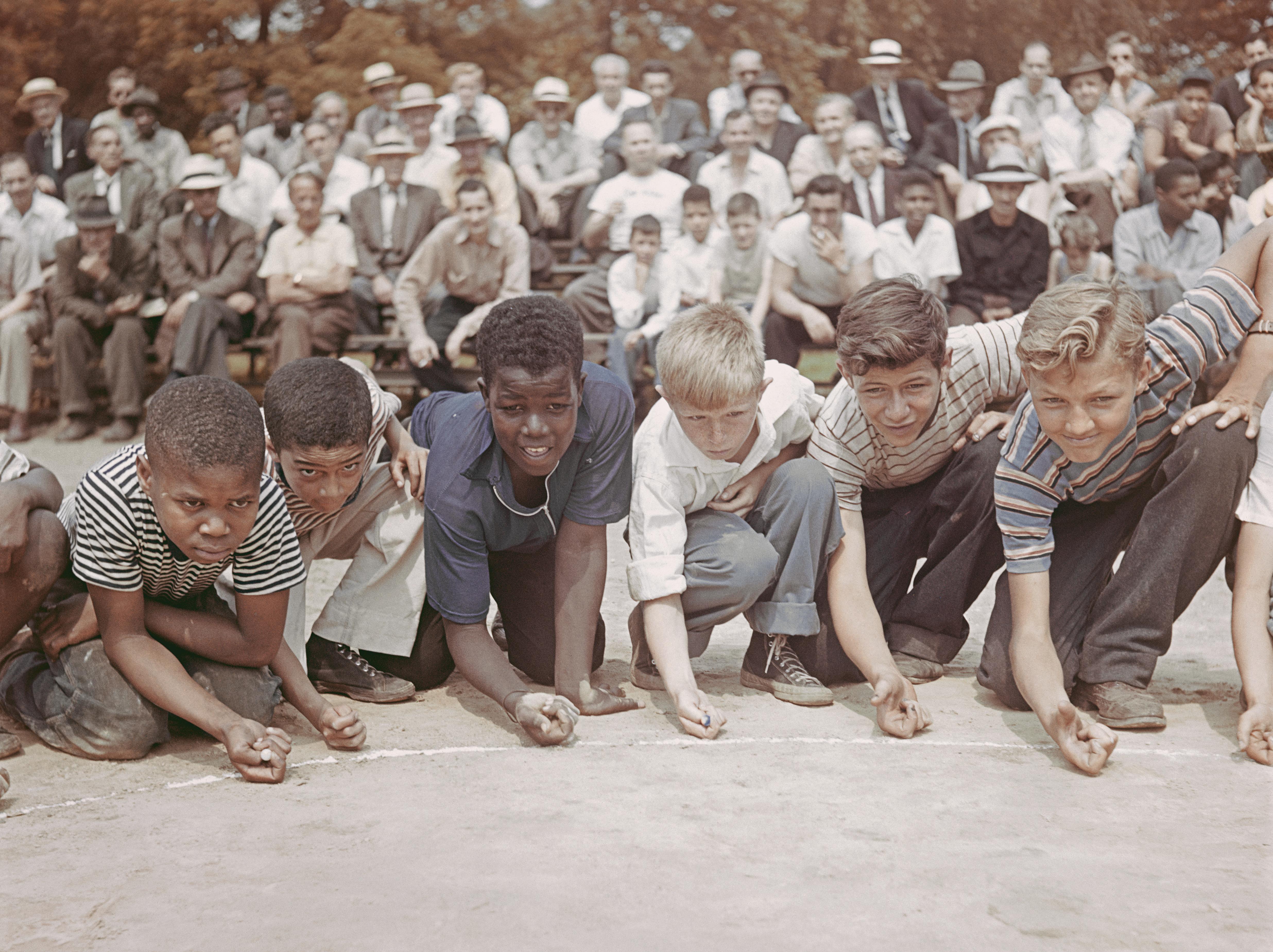 'Marbles Championship' 1947 Slim Aarons Limited Estate Edition Print 

A group of boys competing in a marble championship in Central Park, New York City, 1947. 
(Photo by Slim Aarons/Hulton Archive/Getty Images)

Produced from the original