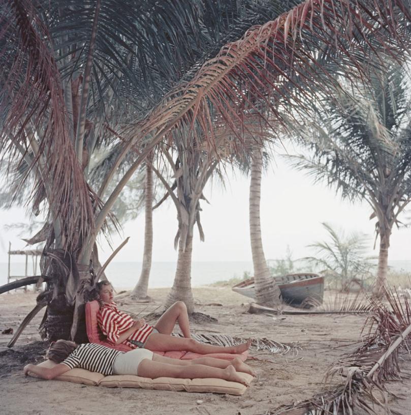 Marsha Gayle 
1957
by Slim Aarons

Slim Aarons Limited Estate Edition

Marsha Gayle (right) and a friend relax on a deserted beach near Calabash Bay, Andros Island, Bahamas, 1957. 

unframed
c type print
printed 2023
20 x 20"  - paper size


Limited