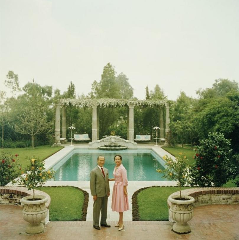 Merle Oberon 
1958
by Slim Aarons

Slim Aarons Limited Estate Edition

 Indian-born actress Merle Oberon (1911 – 1979) with her husband, Italian industrialist Bruno Pagliai, in the garden of their home in Acapulco, 1958. The sculptures were found at