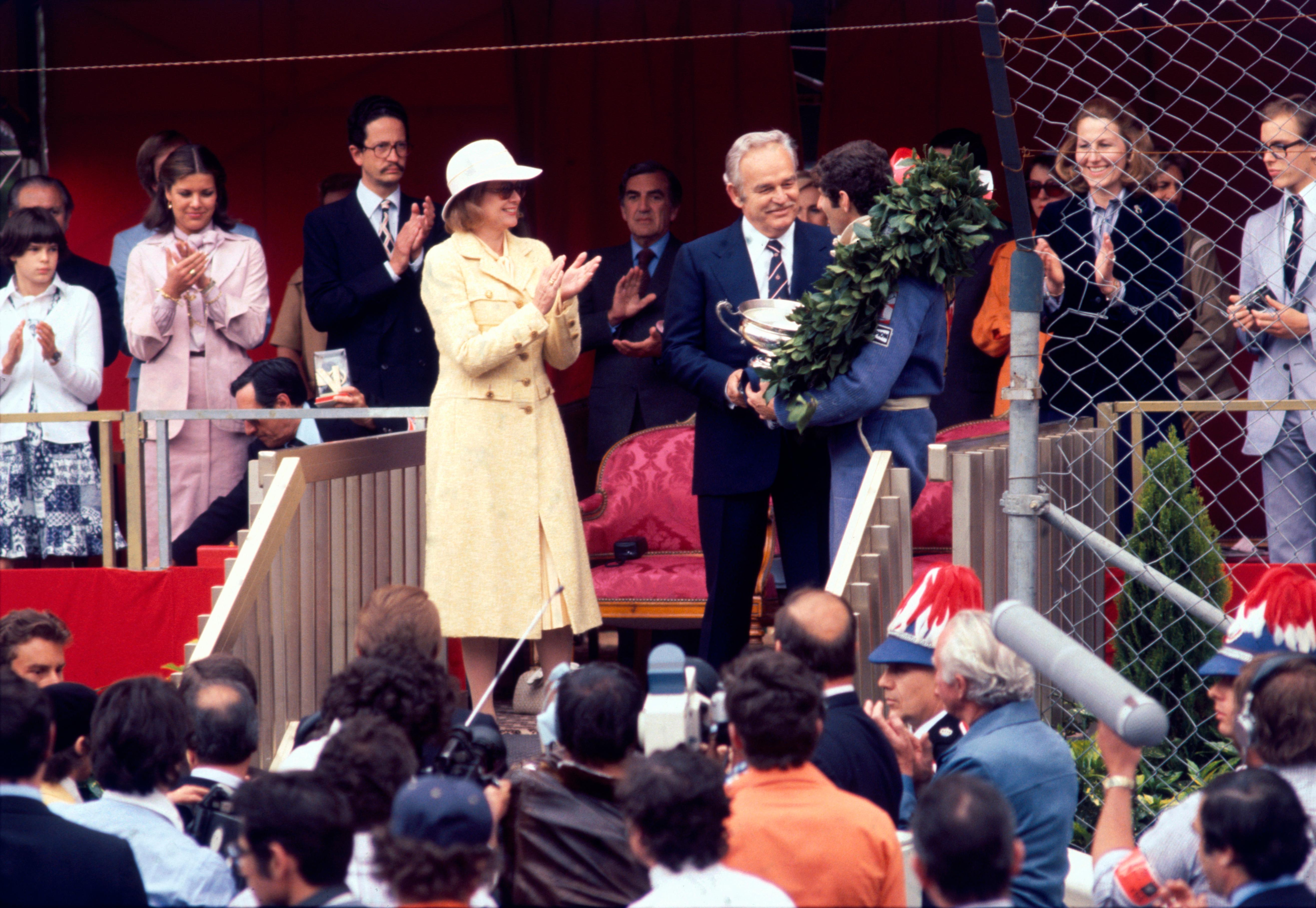 'Monaco Grand Prix' 1977 Slim Aarons Limited Estate Edition Print 

Left to right: princesses Stephanie, Caroline and Grace (1929 - 1982) of Monaco applaud as Prince Rainier III (1923 - 2005) presents a trophy to South African racing driver Jody
