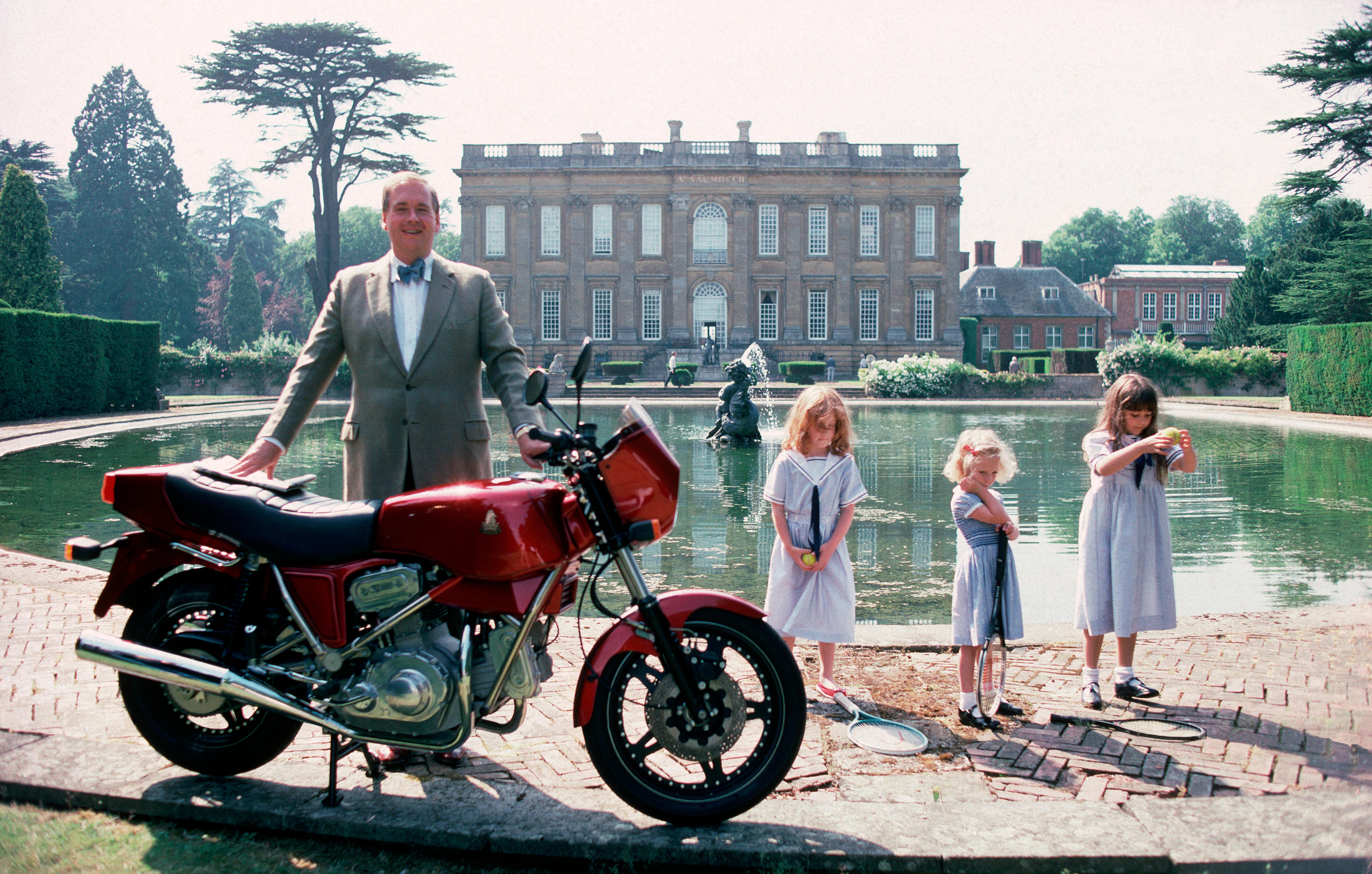 'Motorcycling Lord' 1990 Slim Aarons Limited Estate Edition Print 

Lord Hesketh, Minister of State at the Department of Trade and Industry,  with his motorbike, a Hesketh V1000, by the lake in the grounds of his family estate Easton Neston House,