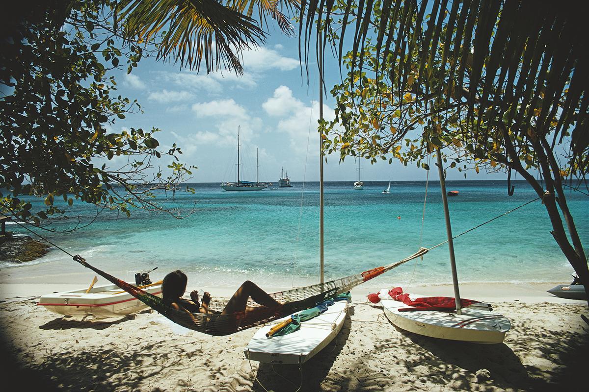 'Mustique' 

March 1973: Linda Ashland relaxes in a beach hammock on the island of Mustique in the Grenadines. 

Paper Size  24x20 inches / 60 x 50 cm 
 
Estate Stamped Collection Edition to 150 

Photo by Slim Aarons

Printed in 2025

Limited to