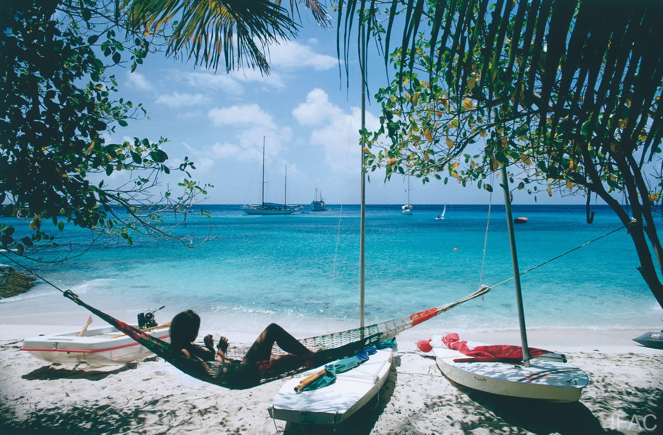 March 1973: Linda Ashland relaxes in a beach hammock on the island of Mustique in the Grenadines. 

Estate stamped and hand numbered edition of 150 with certificate of authenticity from the estate. 

Slim Aarons (1916-2006) worked mainly for society