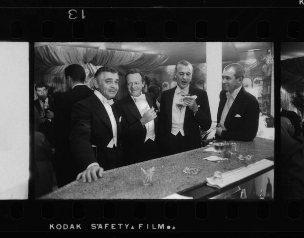 Neujahr im Romanoff's 
1955
von Slim Aarons

Slim Aarons Limited Estate Edition

Die Filmstars (von links nach rechts) Clark Gable (1901 - 1960), Van Heflin (1910 - 1971), Gary Cooper (1901 - 1961) und James Stewart (1908 - 1997) amüsieren sich bei