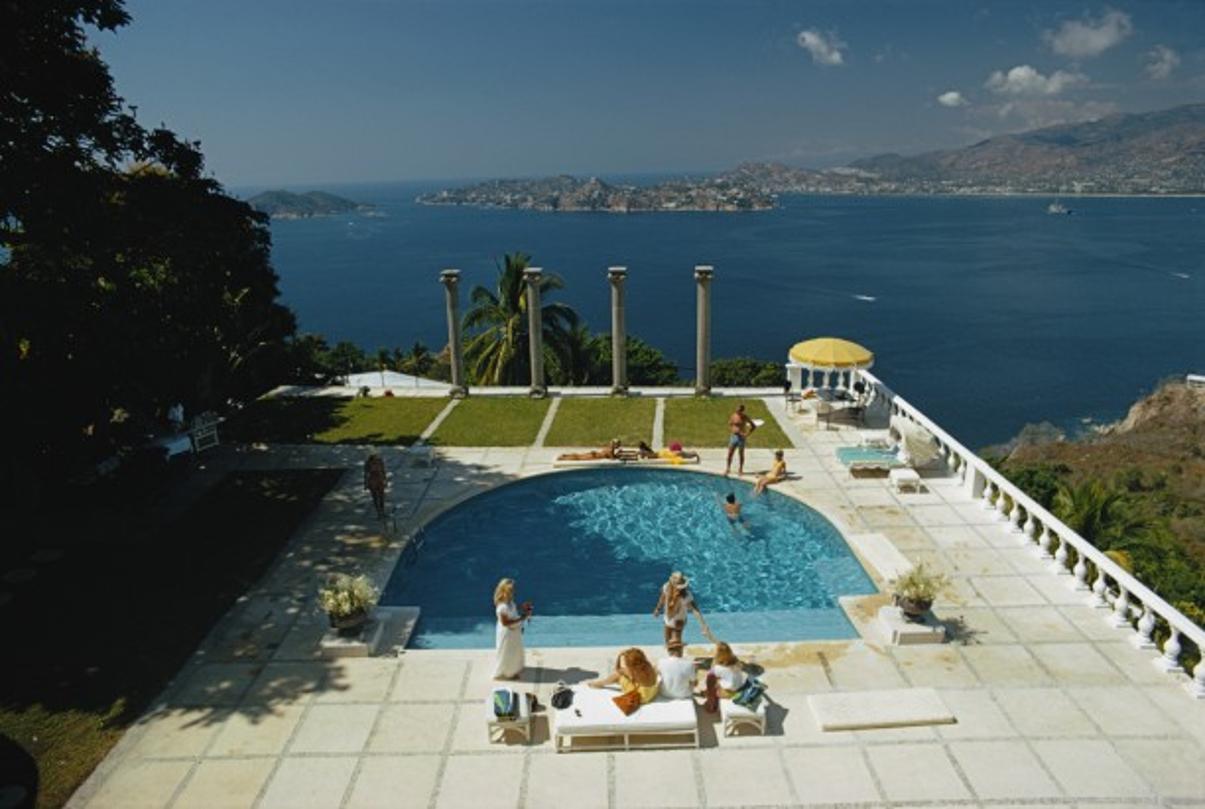 Nirvana 
1972
by Slim Aarons

Slim Aarons Limited Estate Edition

The pool at Villa Nirvana, Acapulco, Mexico. Old Acapulco can be seen across the bay. 1972. Original Artwork: A Wonderful Time – Slim Aarons

unframed
c type print
printed 2023
16×20