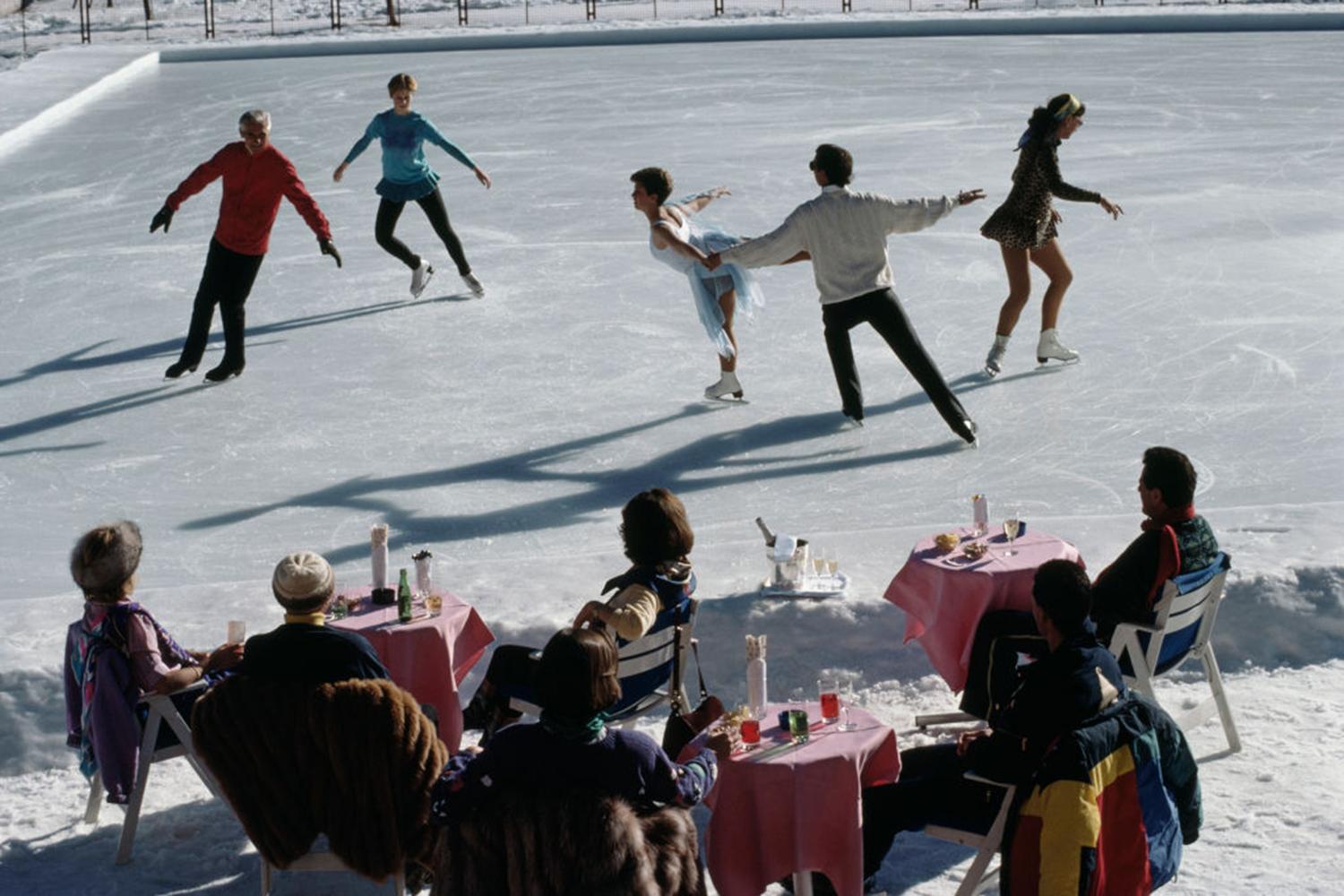 This late 1980s winter landscape photograph, captured by society photographer Slim Aarons, features people ice skating at the Palace Hotel, St. Moritz, Switzerland, 1989.

This is an estate stamped and hand numbered edition of 150 with certificate