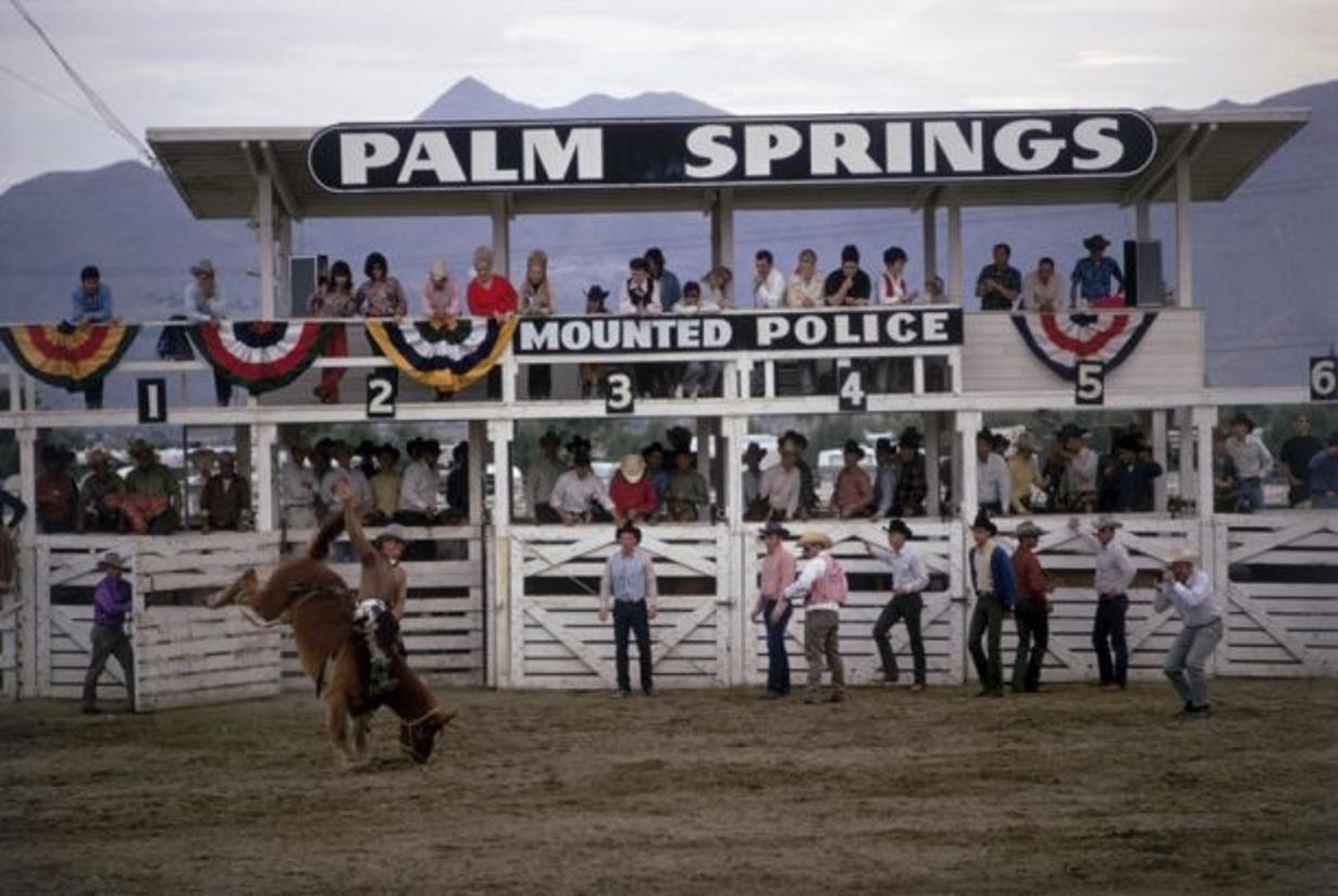 Palm Springs Rodeo 
1970
by Slim Aarons

Slim Aarons Limited Estate Edition

Spectators watch from the stand as a contestant rides a bucking horse at the Palm Springs Mounted Police Rodeo, Palm Springs, California, January 1970. 

unframed
c type