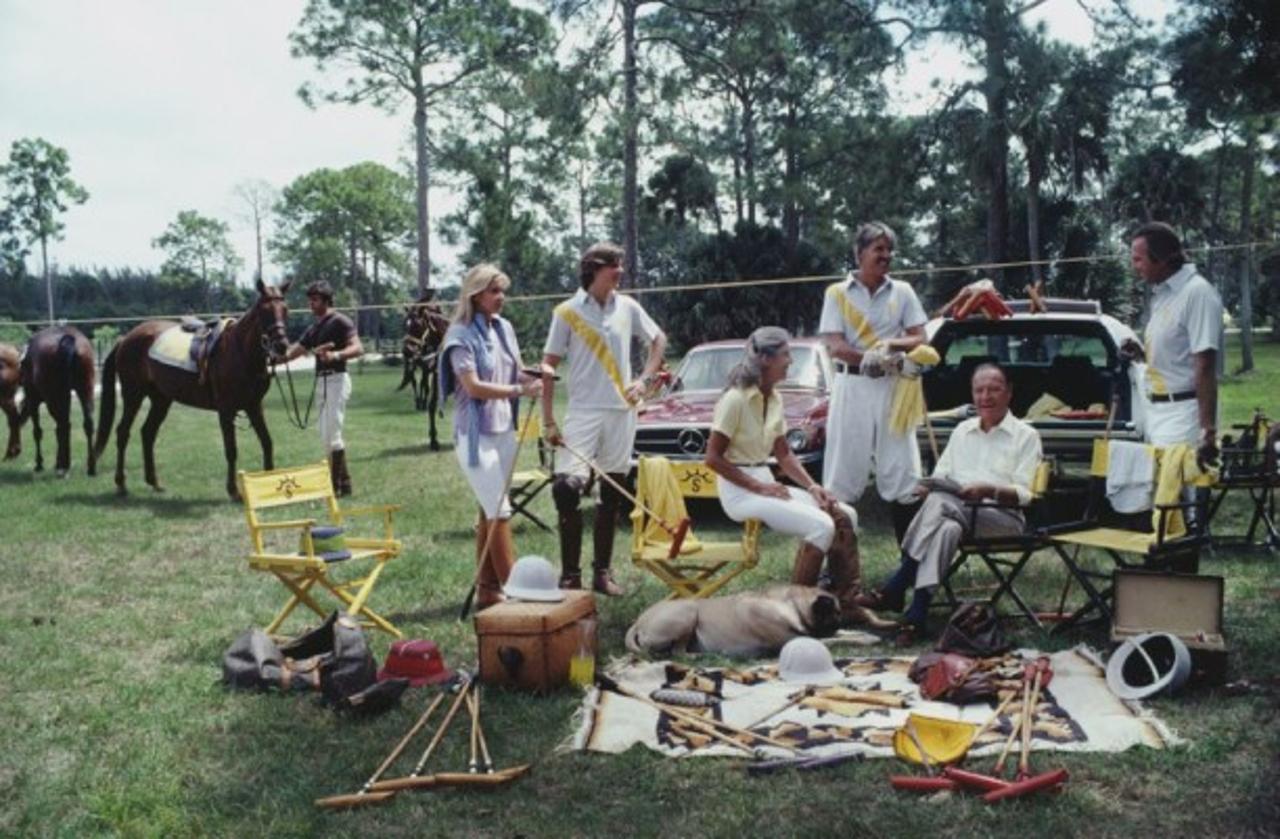 Polo Party 
1981
by Slim Aarons

Slim Aarons Limited Estate Edition

Paul Butler, patriarch of one of America’s foremost polo families, with his son, daughter, grandchildren and son-in-law, Palm Beach, April 1981. Left to right: Adam Butler, Reutie
