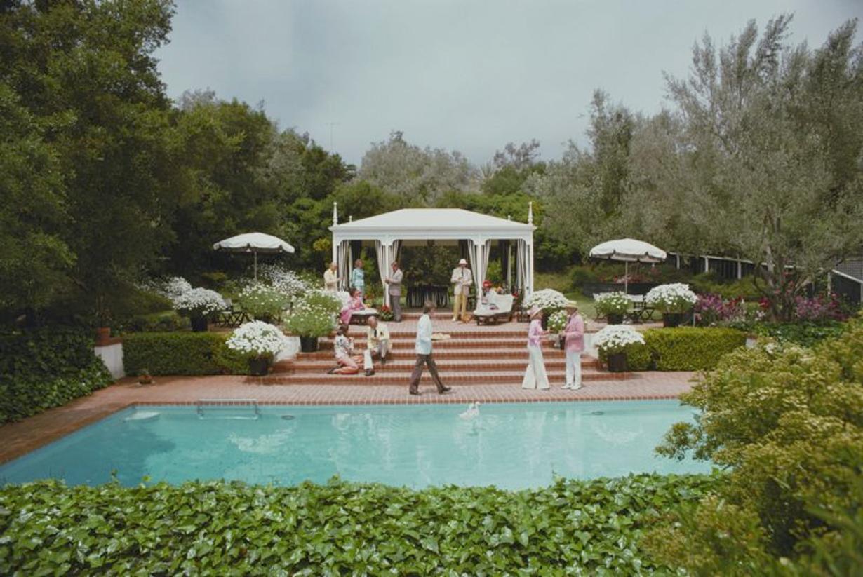 Poolside Drinks 
1975
by Slim Aarons

Slim Aarons Limited Estate Edition

Guests around the pool at Dorothy Laughlin’s Santa Barbara home.

unframed
c type print
printed 2023
16×20 inches - paper size


Limited to 150 prints only – regardless of