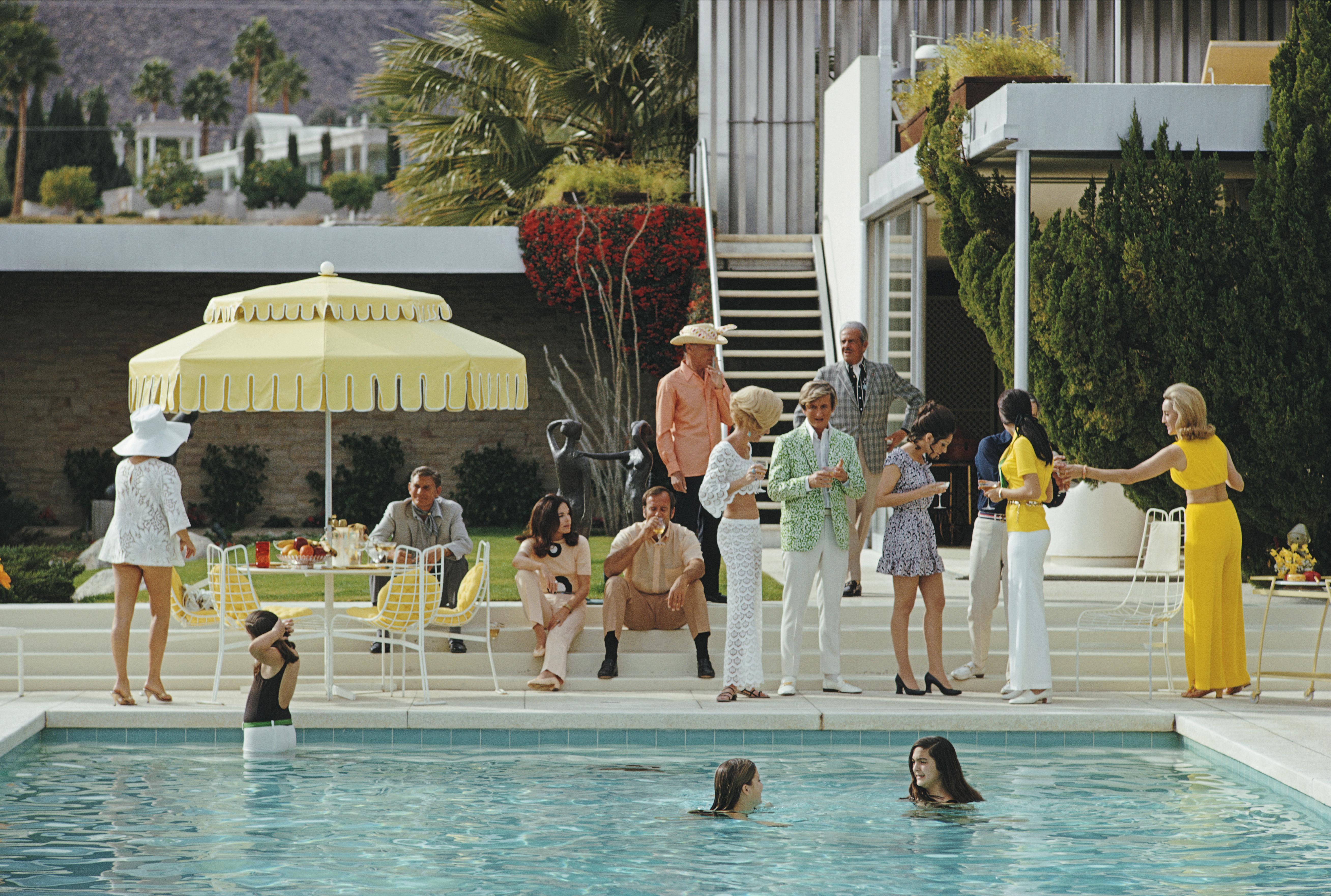 'Poolside Gathering' 1970 Slim Aarons Limited Estate Edition Print 

January 1970: The Kaufmann Desert House in Palm Springs, California, designed by Richard Neutra in 1946 for businessman Edgar J. Kaufmann and now owned by Nelda Linsk (right, in