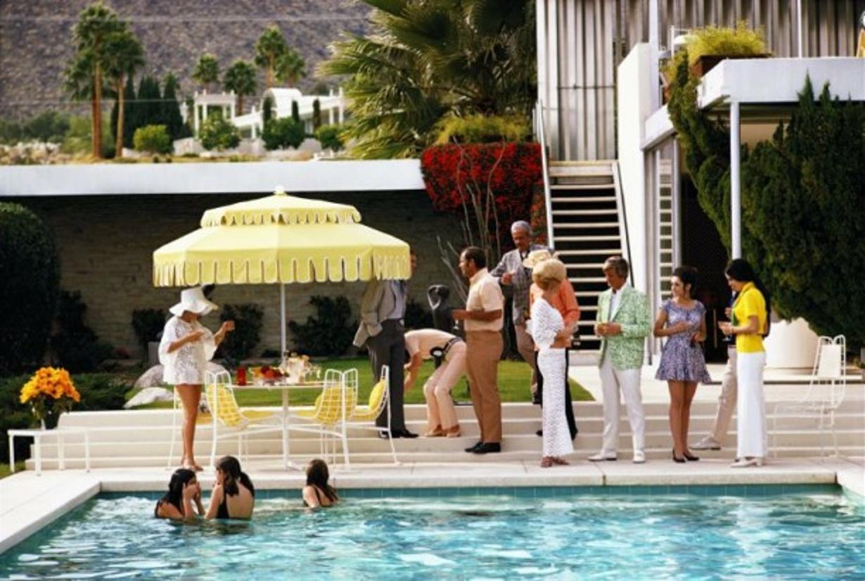 Poolside Party
1970
by Slim Aarons

Slim Aarons Limited Estate Edition

Guests by the pool at Nelda Linsk’s desert house in Palm Springs, January 1970. The house was designed by Richard Neutra for Edgar J. Kaufmann.

unframed
c type print
printed