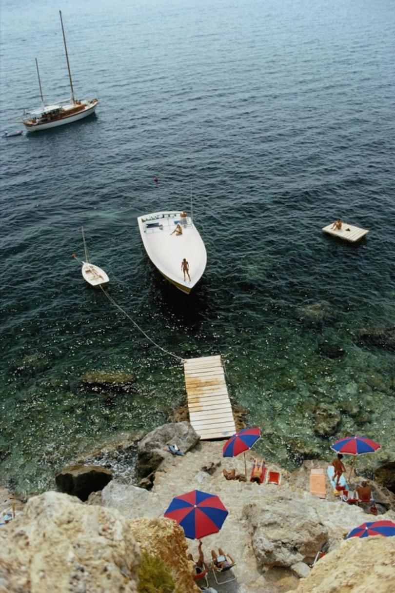 Porto Ercole 
1973
by Slim Aarons

Slim Aarons Limited Estate Edition

A Magnum motorboat belonging to Count Filippo Theodoli arrives at the private jetty of the Il Pellicano Hotel in Porto Ercole, Italy, August 1973

unframed
c type print
printed