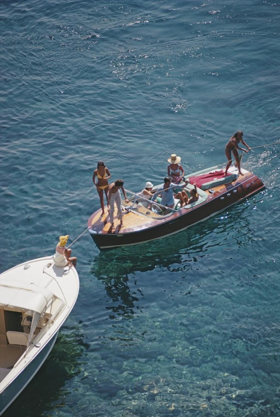 Porto Ercole 
1969
by Slim Aarons

Slim Aarons Limited Estate Edition

Boating in Porto Ercole, Italy, August 1969.

unframed
c type print
printed 2023
24 x 20"  - paper size

Limited to 150 prints only – regardless of paper size

blind embossed