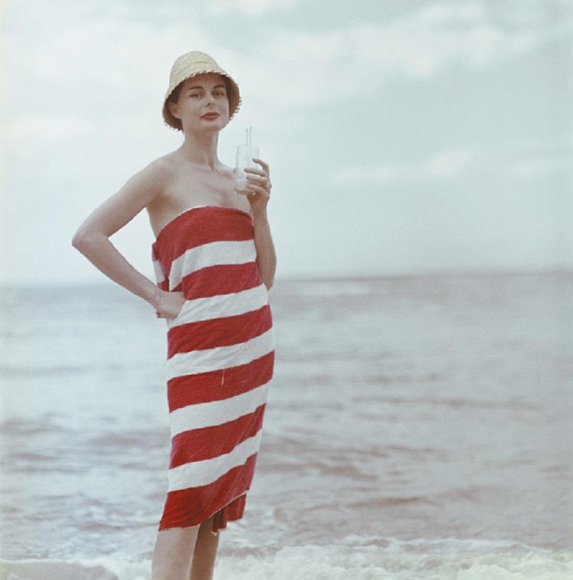 'Pussyfooting' 1958 Slim Aarons Limited Estate Edition Print 

Actress Dee Hartford, wife of film producer Howard Hawks, sips a Pussyfoot - a mixture of Jamaican fruit juices, Jamaica, 1958. 

Produced from the original transparency
Certificate of