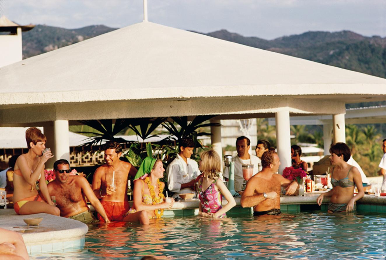 Racquet Club Pool 
1968
by Slim Aarons

Slim Aarons Limited Estate Edition

Guests in the pool at the Villa Vera Racquet Club, Acapulco, Mexico, 1968.

unframed
c type print
printed 2023
20 x 24"  - paper size

Limited to 150 prints only –
