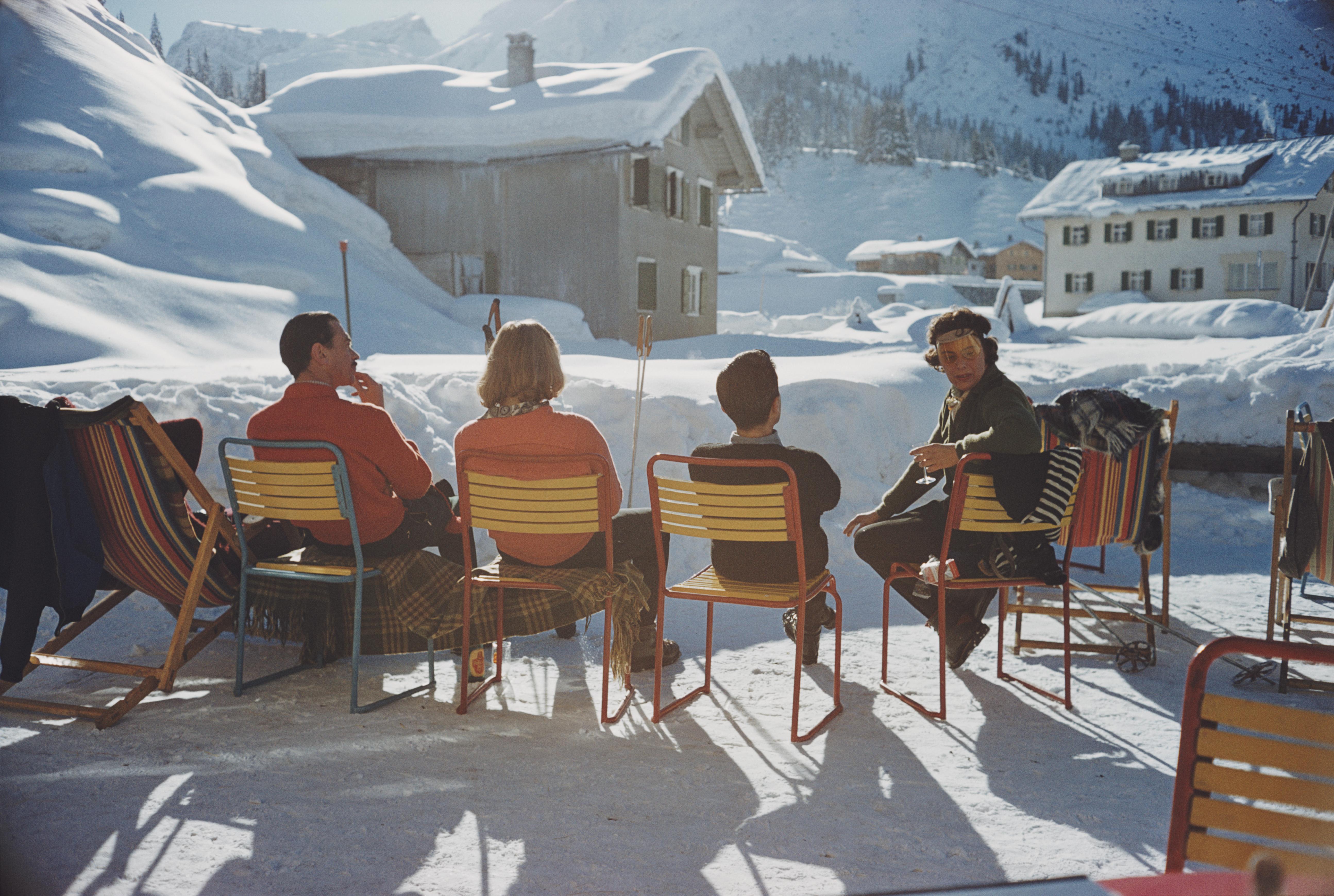 'Relaxing in Lech' 1960 Slim Aarons Limited Estate Edition Print 

A group of people sitting in the sun at the Gasthof Post hotel in the Austrian ski resort of Lech, 1960. 

Produced from the original transparency
Certificate of authenticity