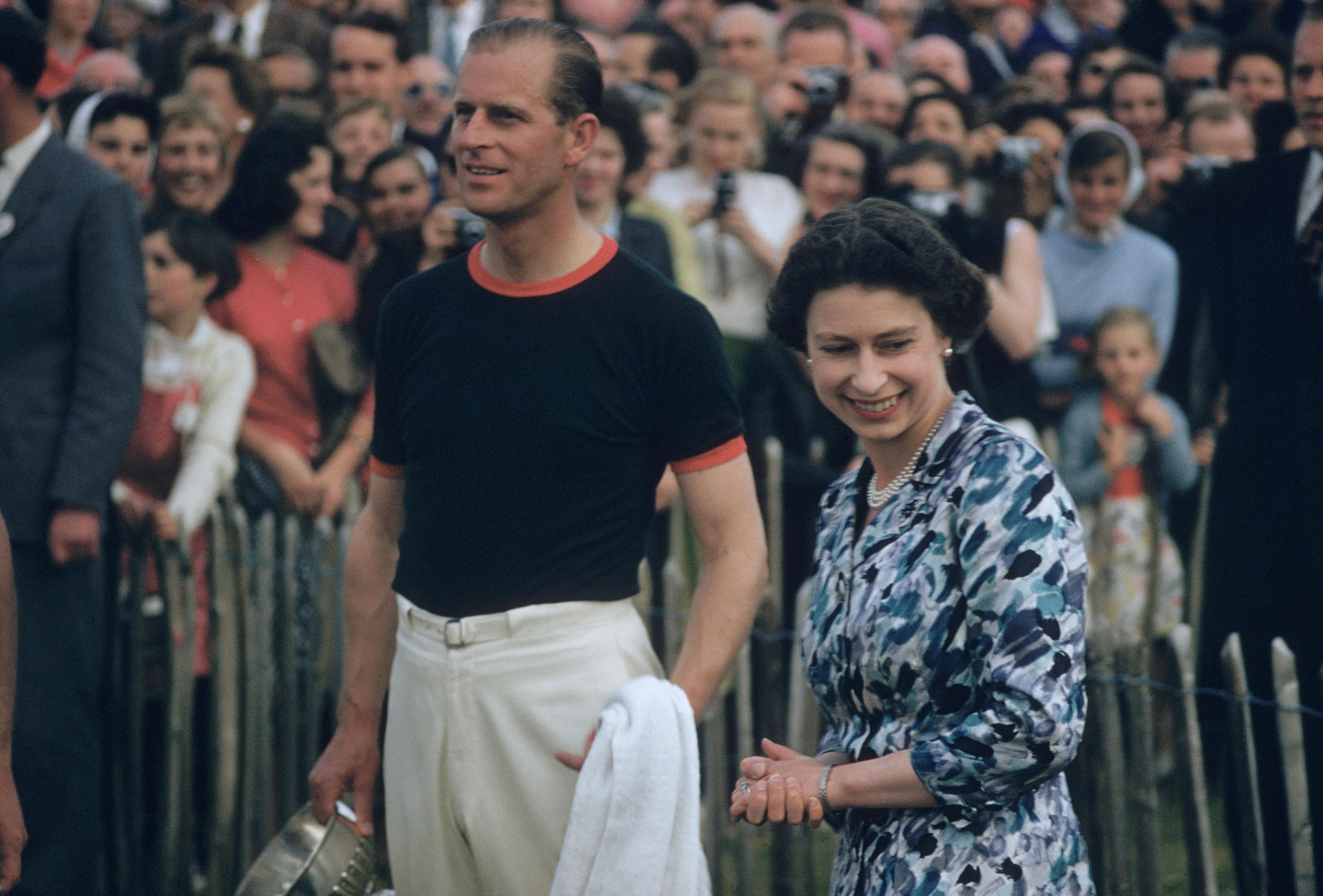 1955: Prince Philip, captain of the Windsor Park Team, with the Windsor Cup after his team beat India during the Ascot week Polo tournament of which he is sponsor.The cup was presented by Queen Elizabeth II who is at his side.

Signed in black ink