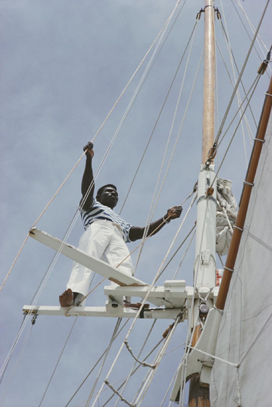 Sailing In Lyford Cay 
1966
by Slim Aarons

Slim Aarons Limited Estate Edition

A crew member tends to the rigging on a yacht in Lyford Cay, Bahamas, April 1966.

unframed
c type print
printed 2023
20 × 16 inches - paper size


Limited to 150 prints