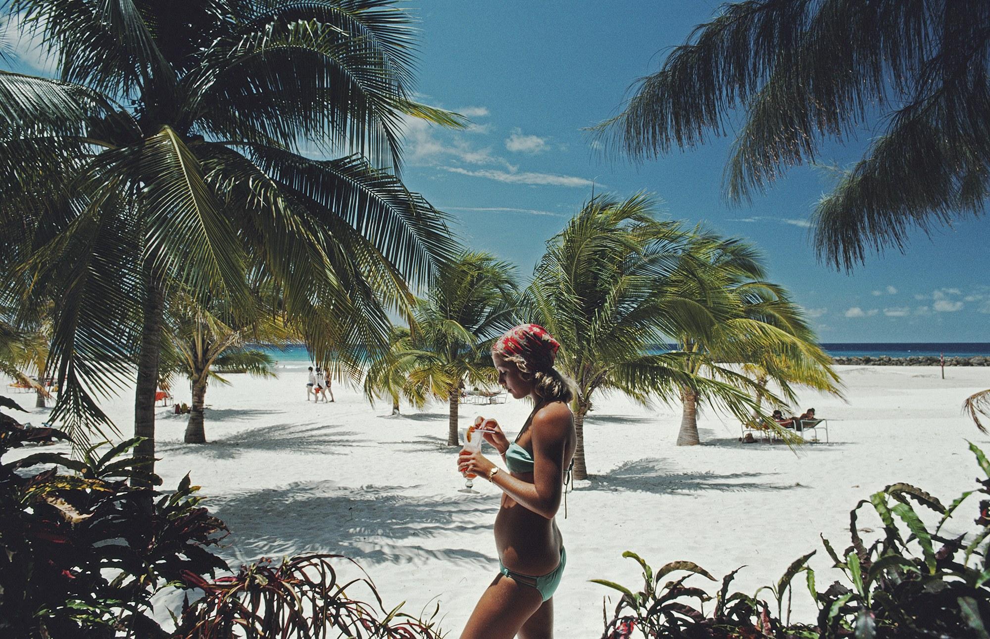 Slim Aarons Landscape Photograph - Sarah Marson Williams with a  cocktail in Barbados 