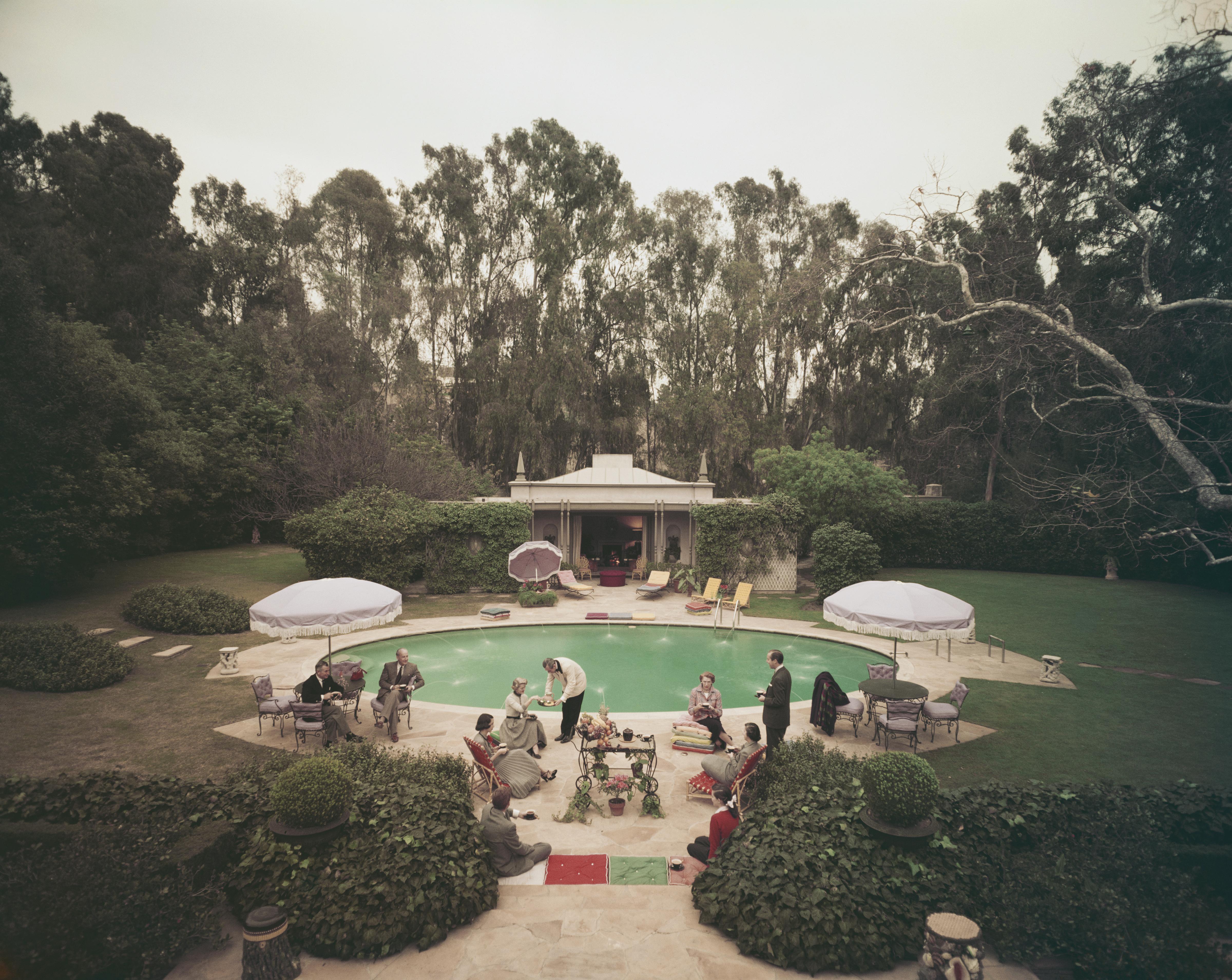 'Scone Madam ?' 1952 Slim Aarons Limited Estate Edition Print 

Interior decorator James Pendleton, his wife and guests spending a quiet Sunday afternoon beside the pool at their home of the last eight years, Beverly Hills, California, 1952.